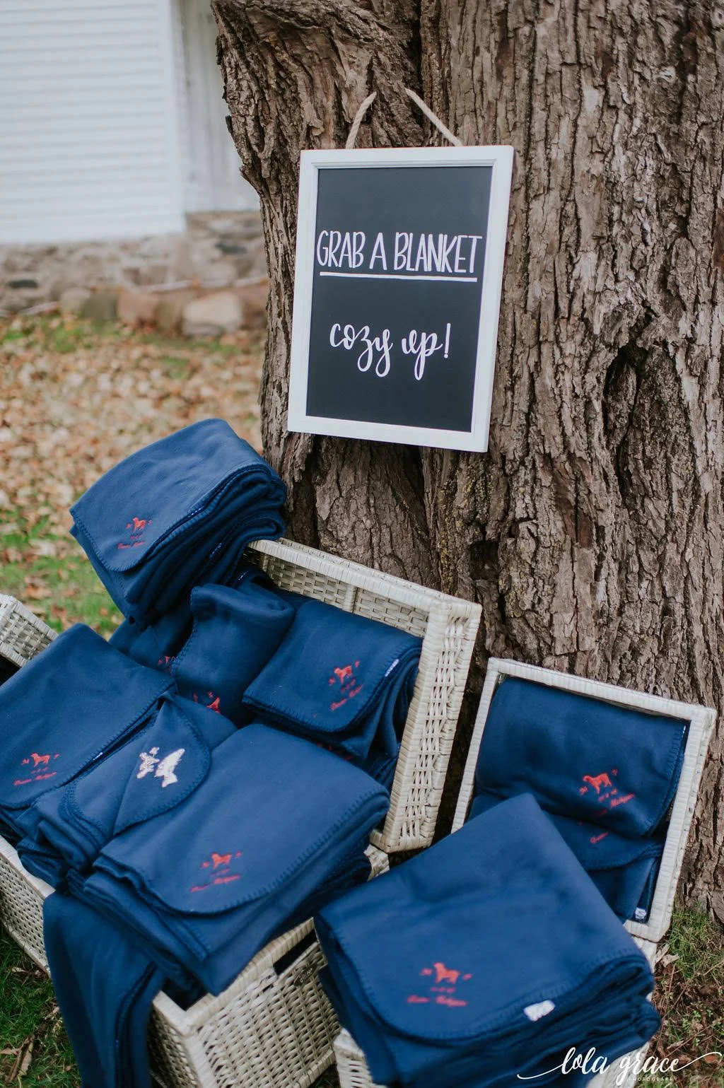 Guests snuggled up in custom monogrammed blankets for their breezy outdoor ceremony.