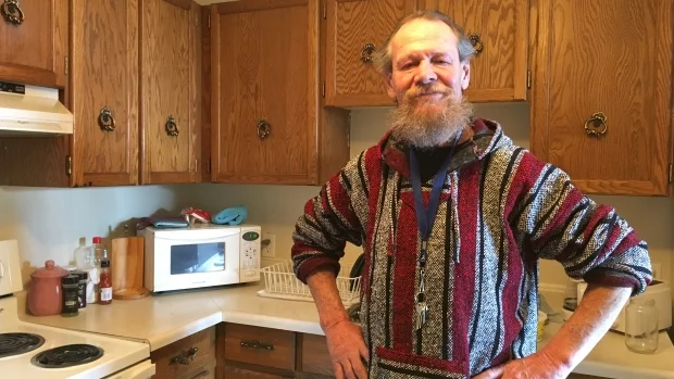 Bob Kastrukoff has had a few run-ins with police during his years on the streets in downtown Regina. Now he has a home and has welcomed officers inside for a visit. (Tory Gillis/CBC)