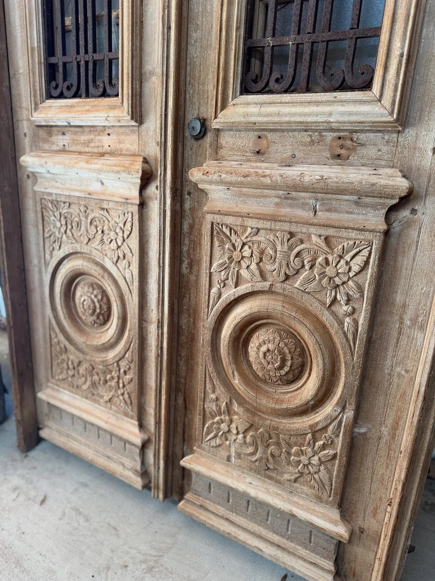 Some antique doors are too good not to share. Showing off the details first with this pair. 

Antique hand-carved doors. Pine doors in frame with iron inserts. Behind the iron are small doors ready for glass. Circa 1890&rsquo;s. French colonies. 

Do