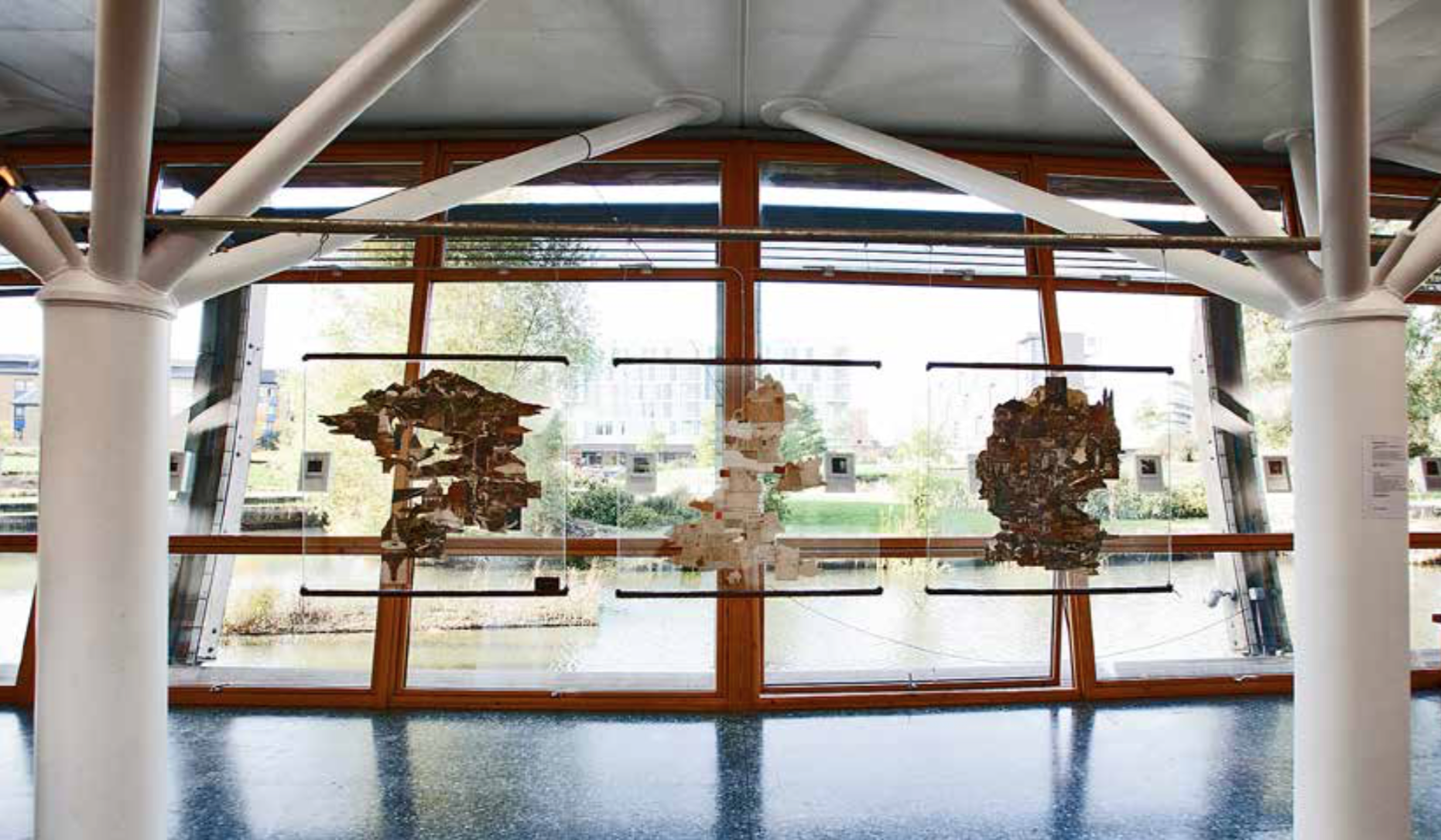 Maps of the West, 2013, Exhibition view : Frieze art fair - TIAF - London Old postcards, glass, steel, polyester resin. Each piece : 90 x 80 x 8 cm Various size installations 
