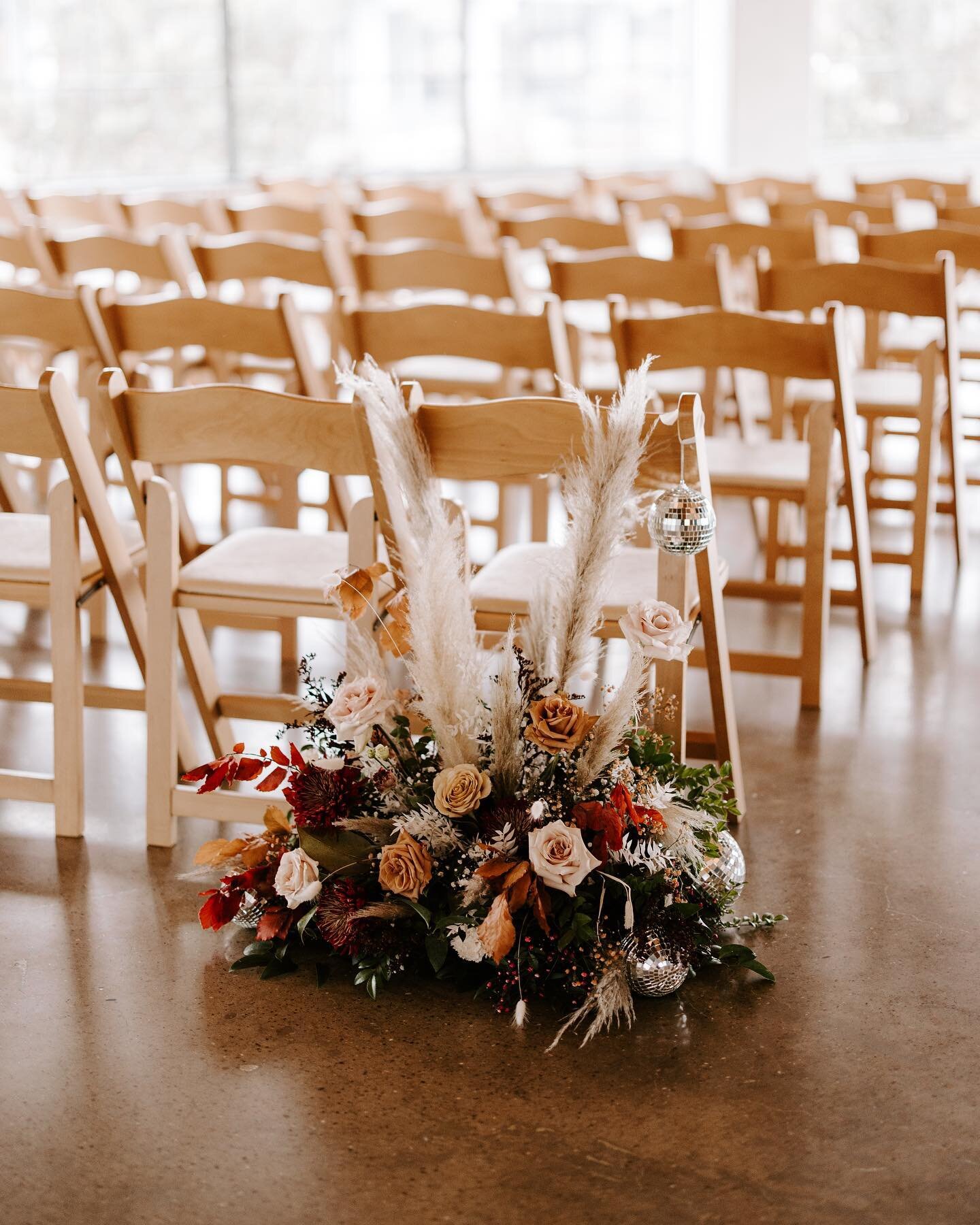 Always repurpose ceremony florals when they can be placed appropriately. It can help maximize budget and leave no florals left behind! These aisle pieces were easily transferred in front of the bride and groom for added decor! 

Photo @heather.photo 