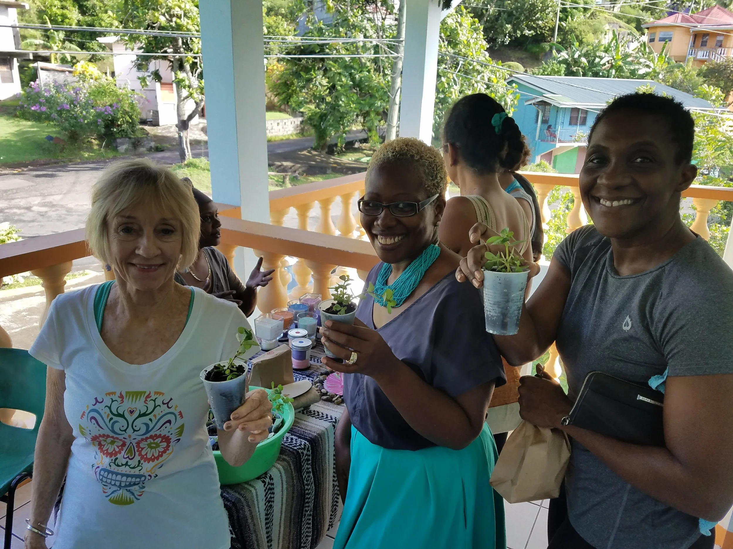 Xandra Fischer, Lucille Sylvester and Paula LaTouche show off their Purslane gifts from our resident farmer Ferron. 