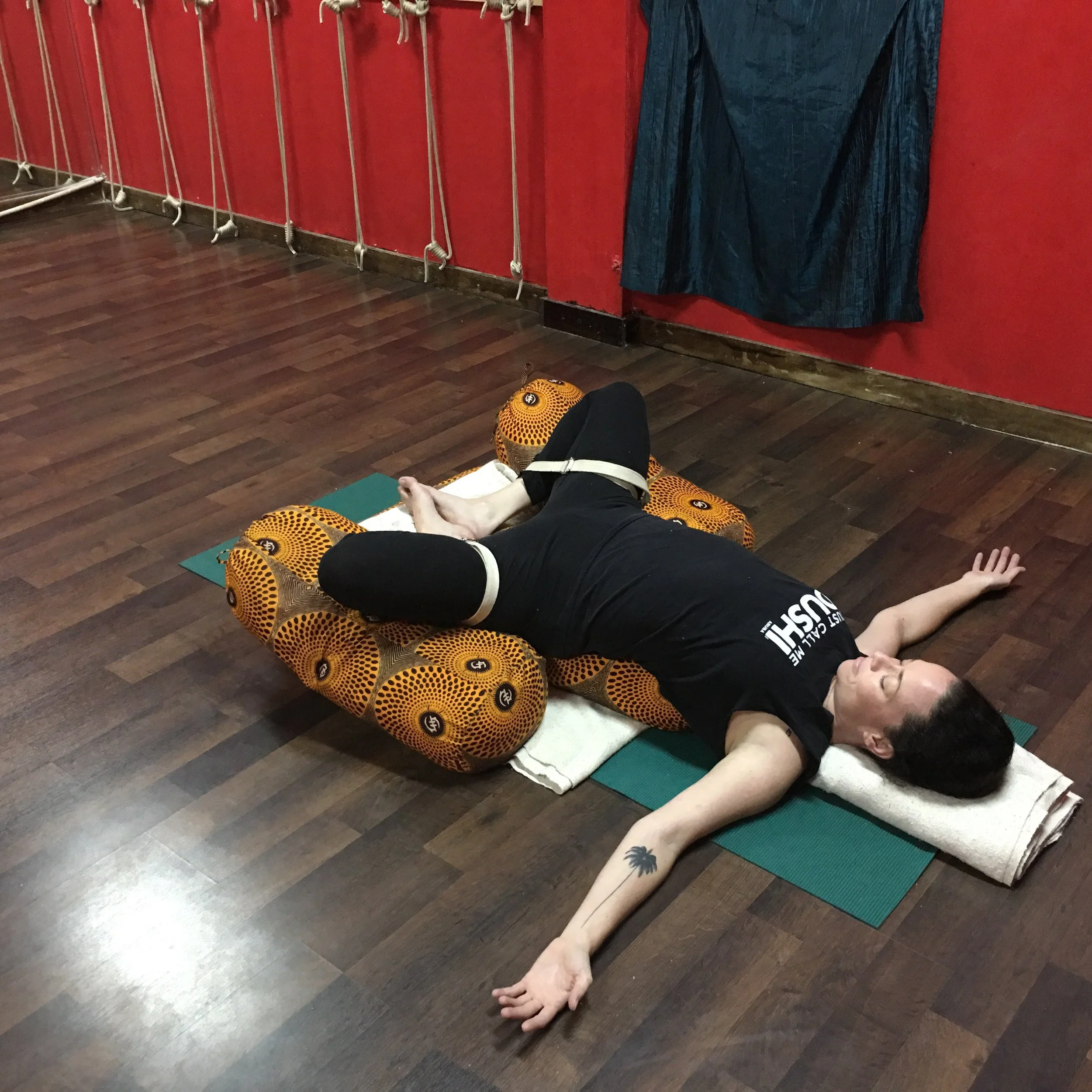 Holly Bynoe, yoga teacher at Cosmosis Yoga Suite (Nassau, Bahamas), in reclined bound angle pose. 
