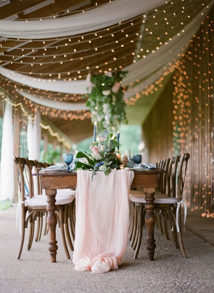 Floral and light pink table arrangement with drape and lighting.jpg