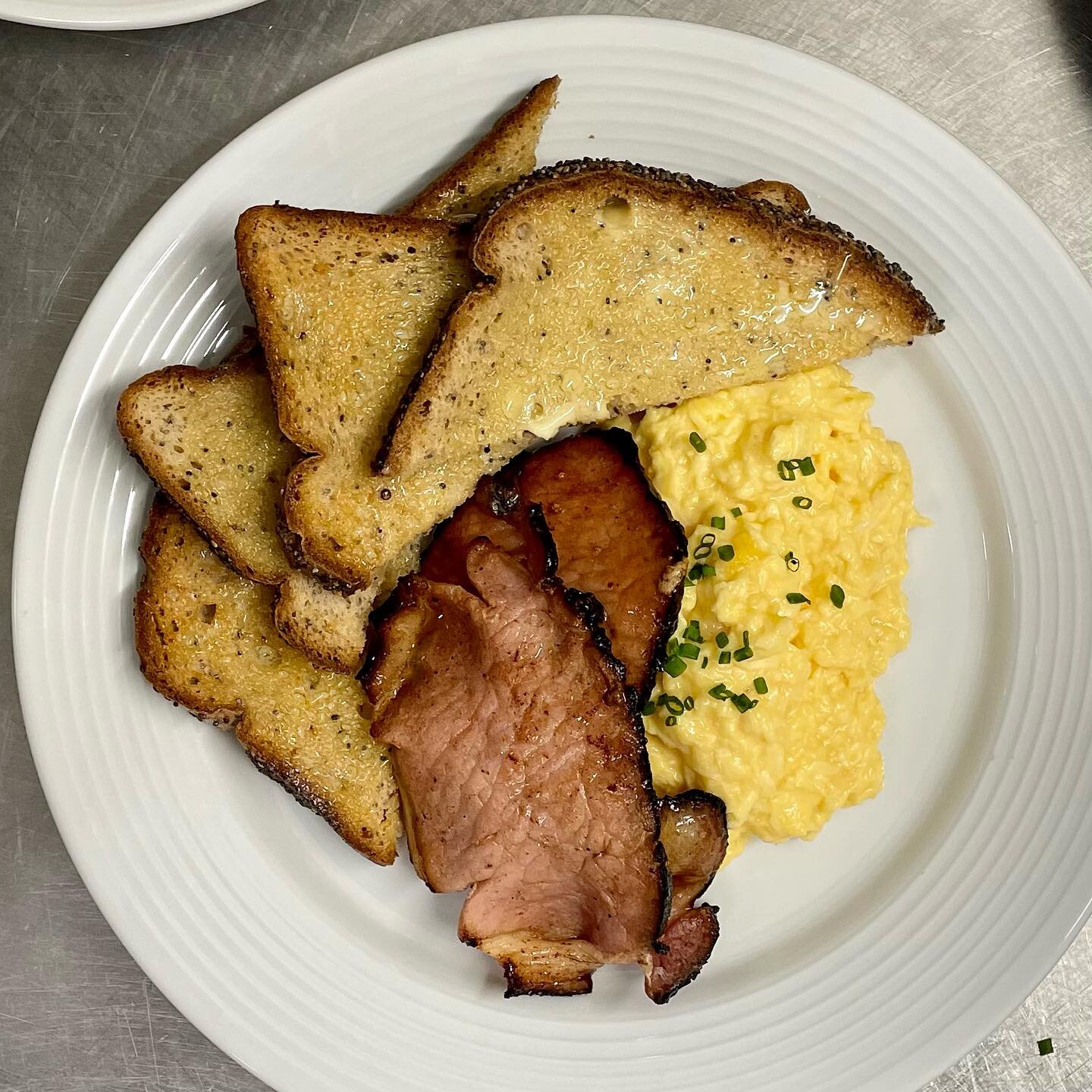 Our gluten-free scrambled eggs on toast with extra treacle-cured bacon. We bake all our own breads except for gluten free, which we buy in especially from @promiseglutenfree and which we find to be the best around.
