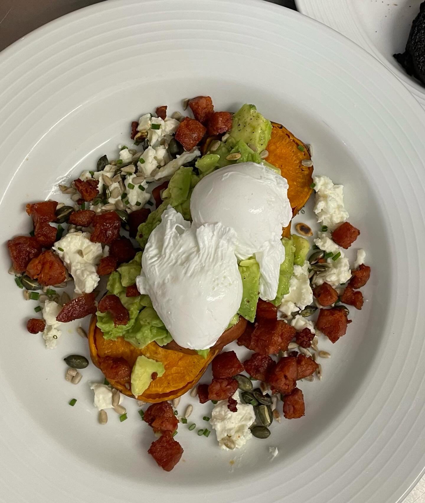 Perfectly poached free range organic eggs on sweet potato &lsquo;toast&rsquo; with avocado, chorizo, feta &amp; toasted seeds. A good start to the day! 🌞