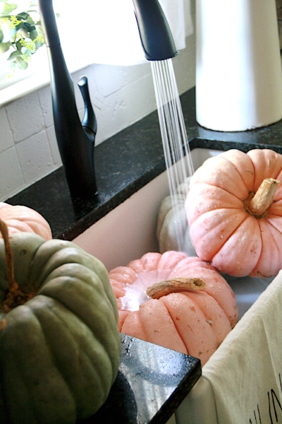 farmhouse sink full of pumpkins