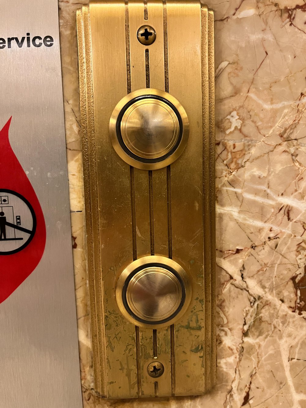 Elevator button with three bas relief lines