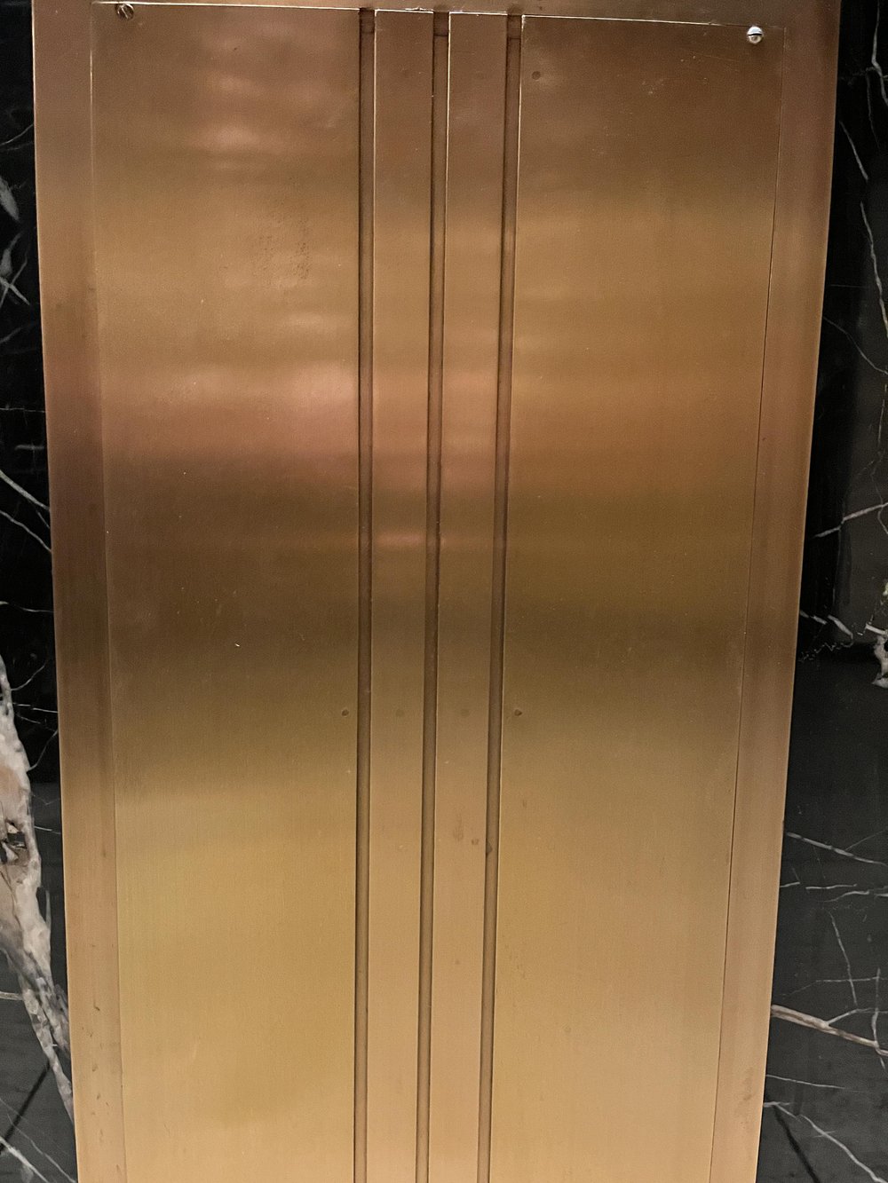 Brass wall panel with three bas relief lines
