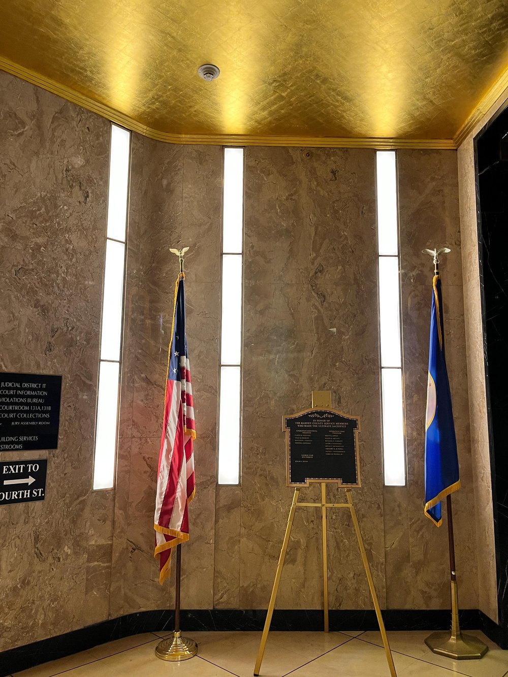 Three lights in lobby with American flag and flag of the state of Minnesota