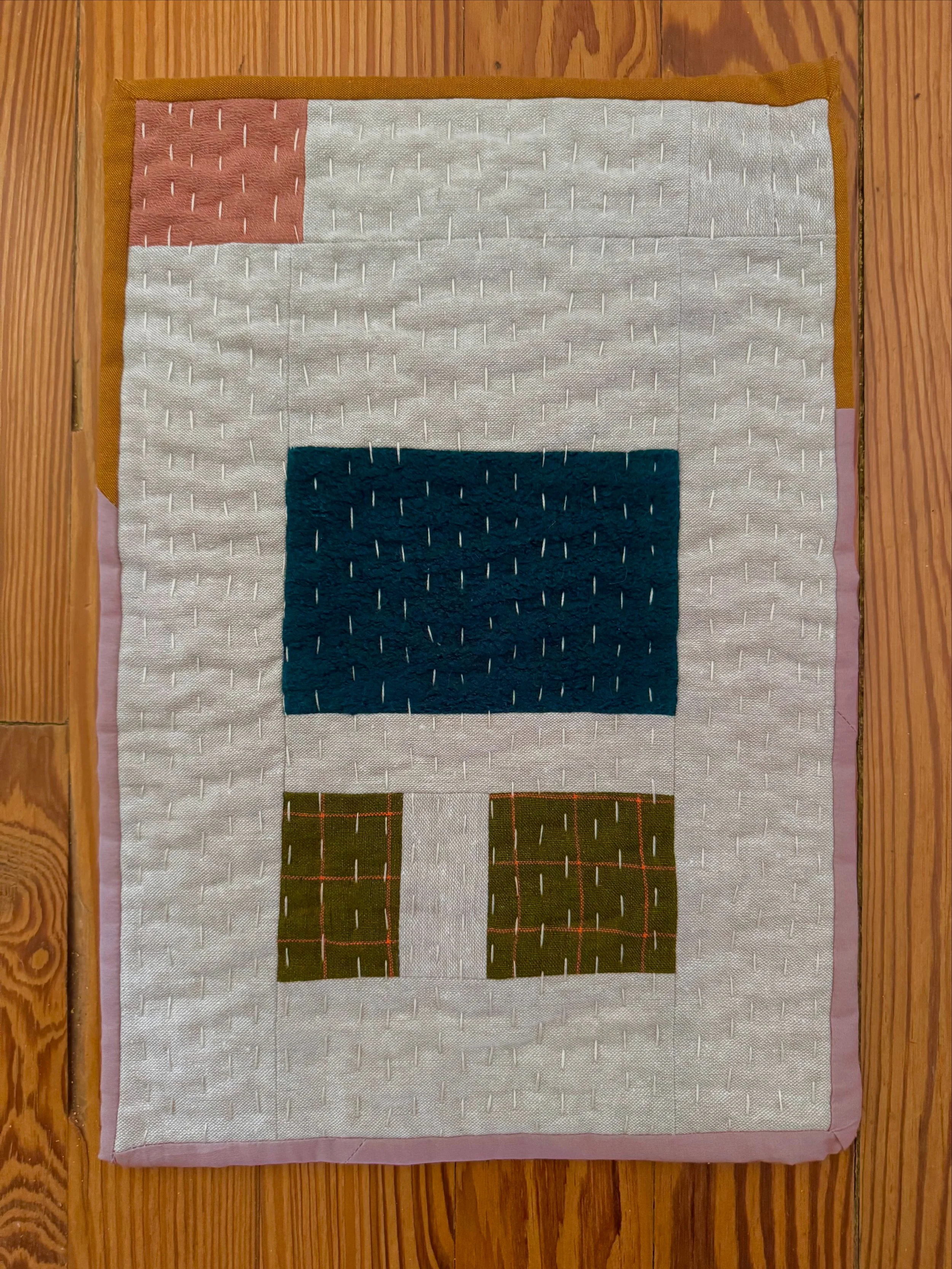 A small hand quilted wall hanging by textile artist Rachel Connor