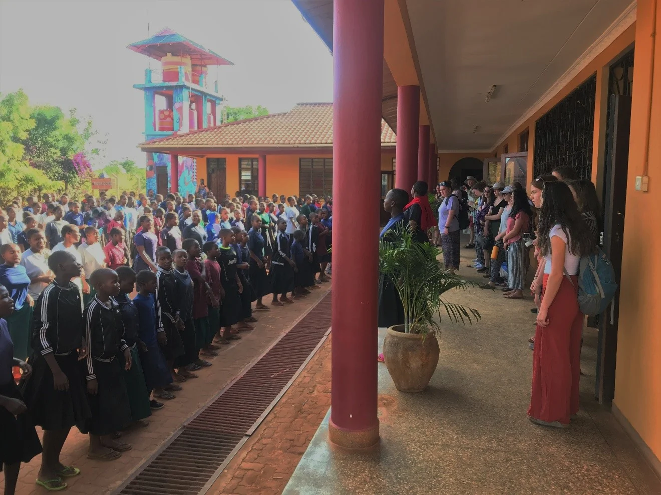 SEGA students sing the school welcome song to visitors during morning assembly.