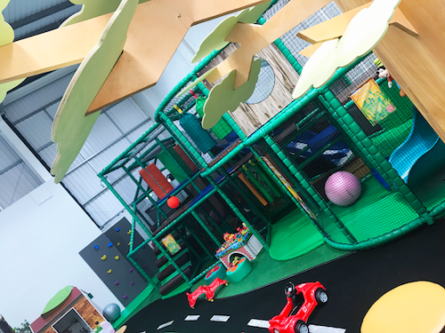 The two tier junior play structure full of games, toys, soft obstacles and a mini climbing wall.
