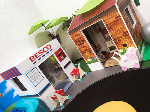 A mini village featuring the 'Besco' shop and a cottage. 