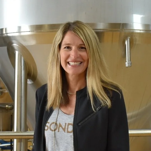 Jen - Chief Marketing Officer Jen remembers her first craft beer as being Kentucky Irish Red Ale, and once the brewery scene in Cincinnati blew up she embraced the trend of constantly trying new beers. Her and her family often travel, and visiting new breweries along the way is a must do. Jen has been doing marketing and graphic design for 20+ years, and loves bringing that knowledge and expertise to her work. When she’s not growing the Sonder brand, she spends time with her husband and two children, enjoys a good work out, catches up on Netflix, and spends time drinking good brews on the patio with the neighbors. When she’s picking out a new beer to try, she’ll try anything with Simcoe hops or a good barrel aged stout, and her Sonder beer of choice is The Midwesterner.