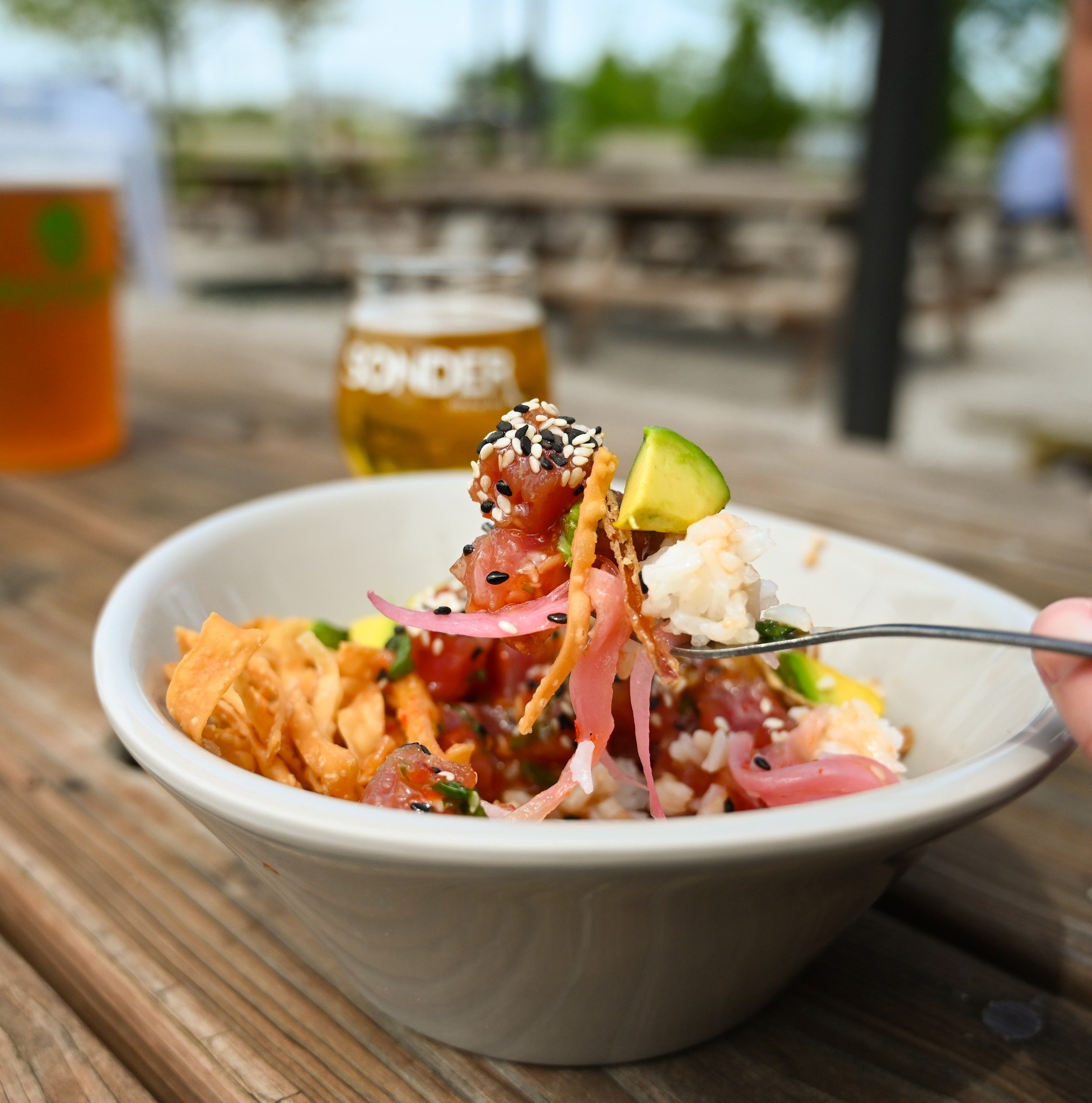 Our Poke Bowl is packed with flavor! This bowl has Ahi Tuna, Avocado, Green Onion, Fried Wontons, Fried Shallots, Mae Ploy (a mild sweet chili sauce), Nori (a type of seaweed), CinSoy Chili Crisp, all on top of a bed of Jasmine Rice. Stop by today to