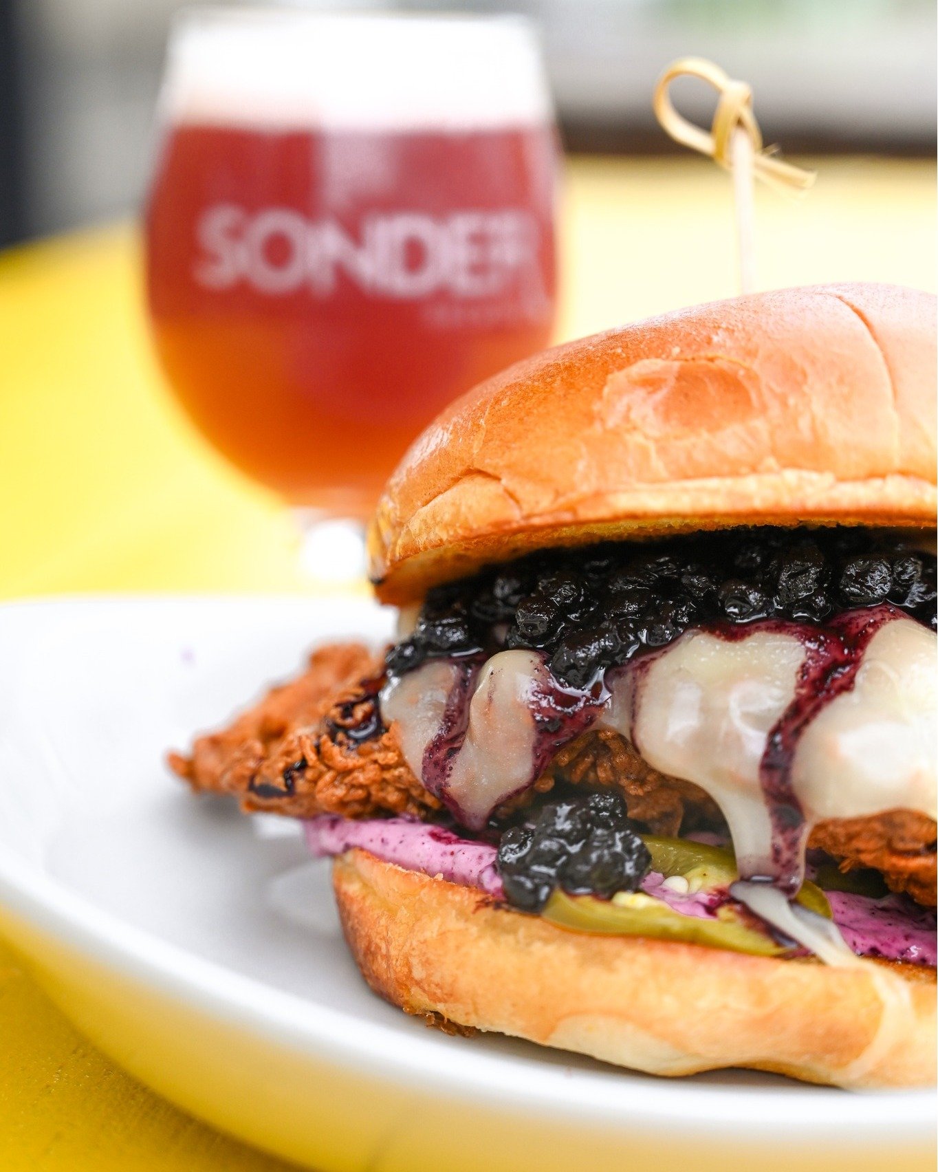 Our new seasonal menu is here! Don&rsquo;t miss out on the Blueberry Crispy Chicken Sandwich with buttermilk-brined chicken, blueberry aioli, white cheddar, spiced compote, and pickled jalape&ntilde;os.