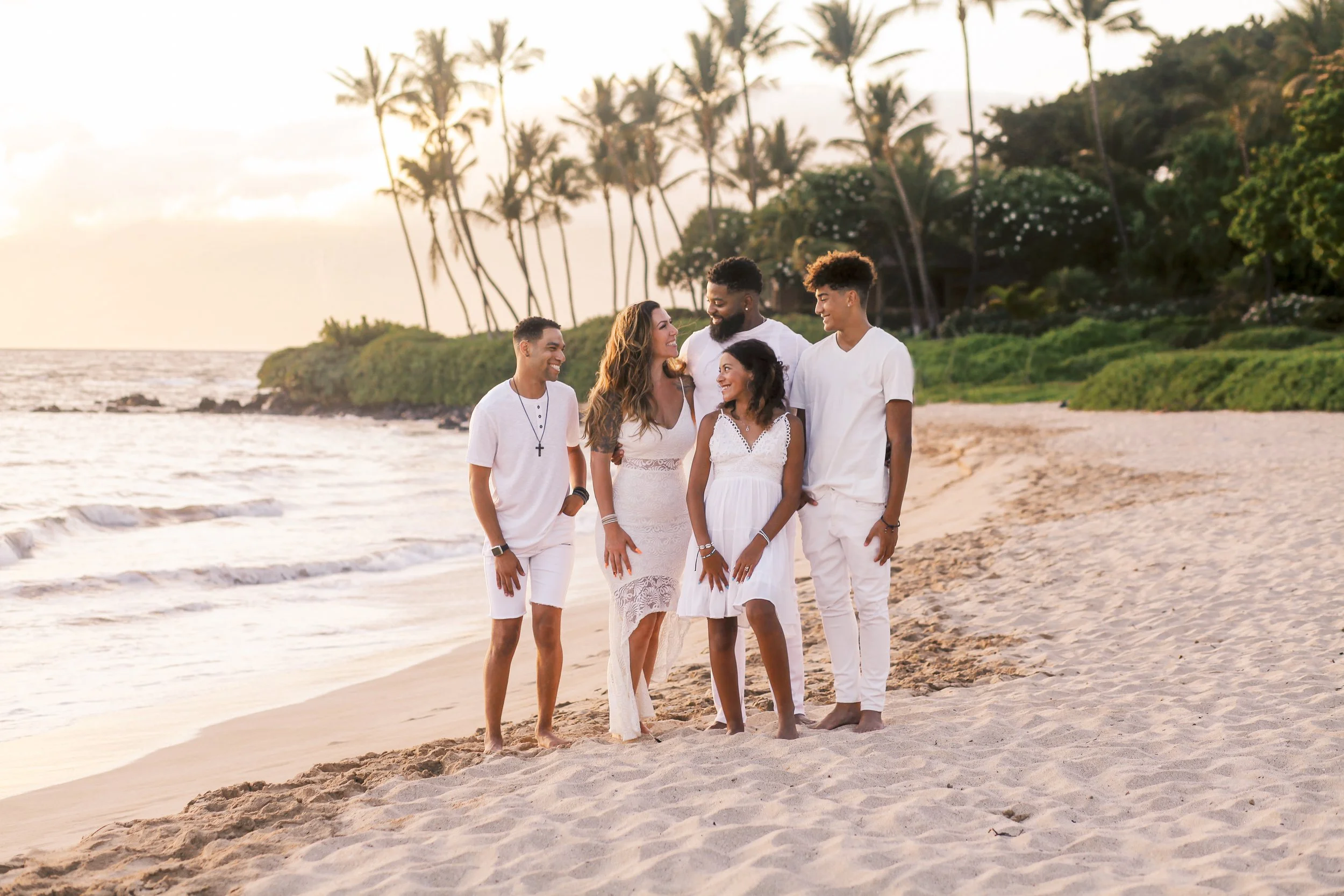 A family photoshoot during golden hour into sunset at Palauea Beach in Wailea Maui.