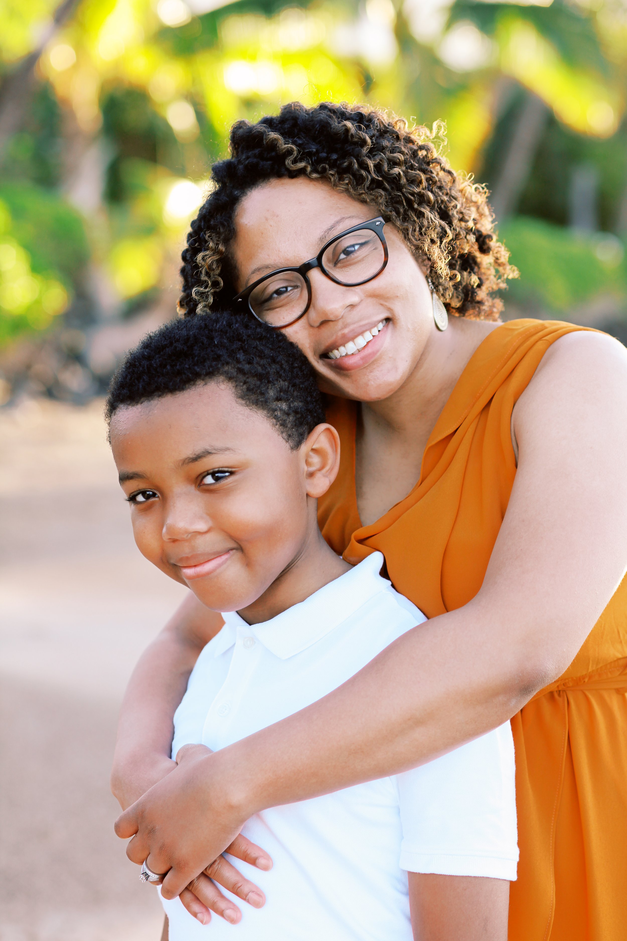 A mother embracing her young son during a photoshoot on the beach in Lahaina Maui.