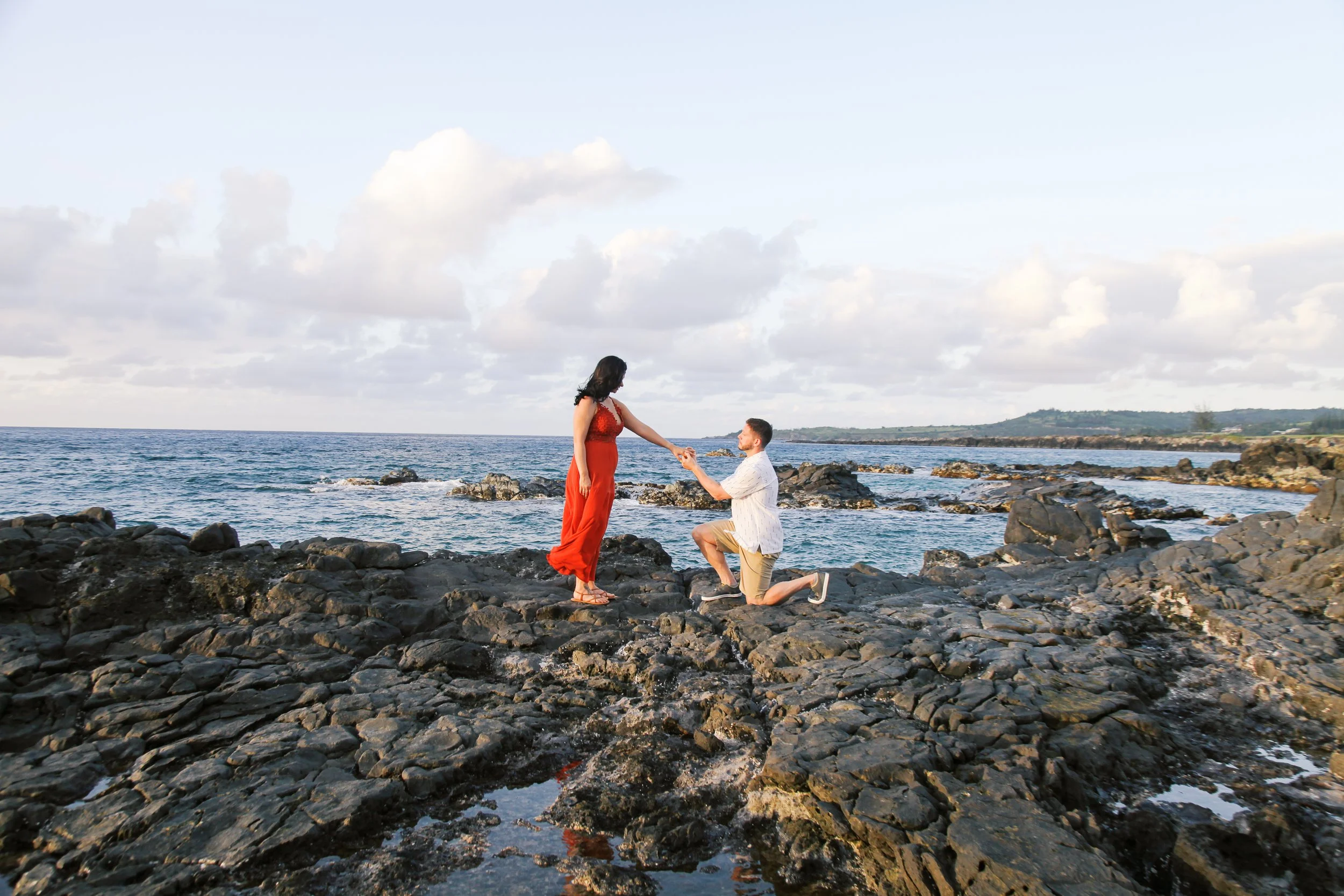 A surprise proposal on the cliffs at Ironwoods Beach in Kapalua Maui Hawaii