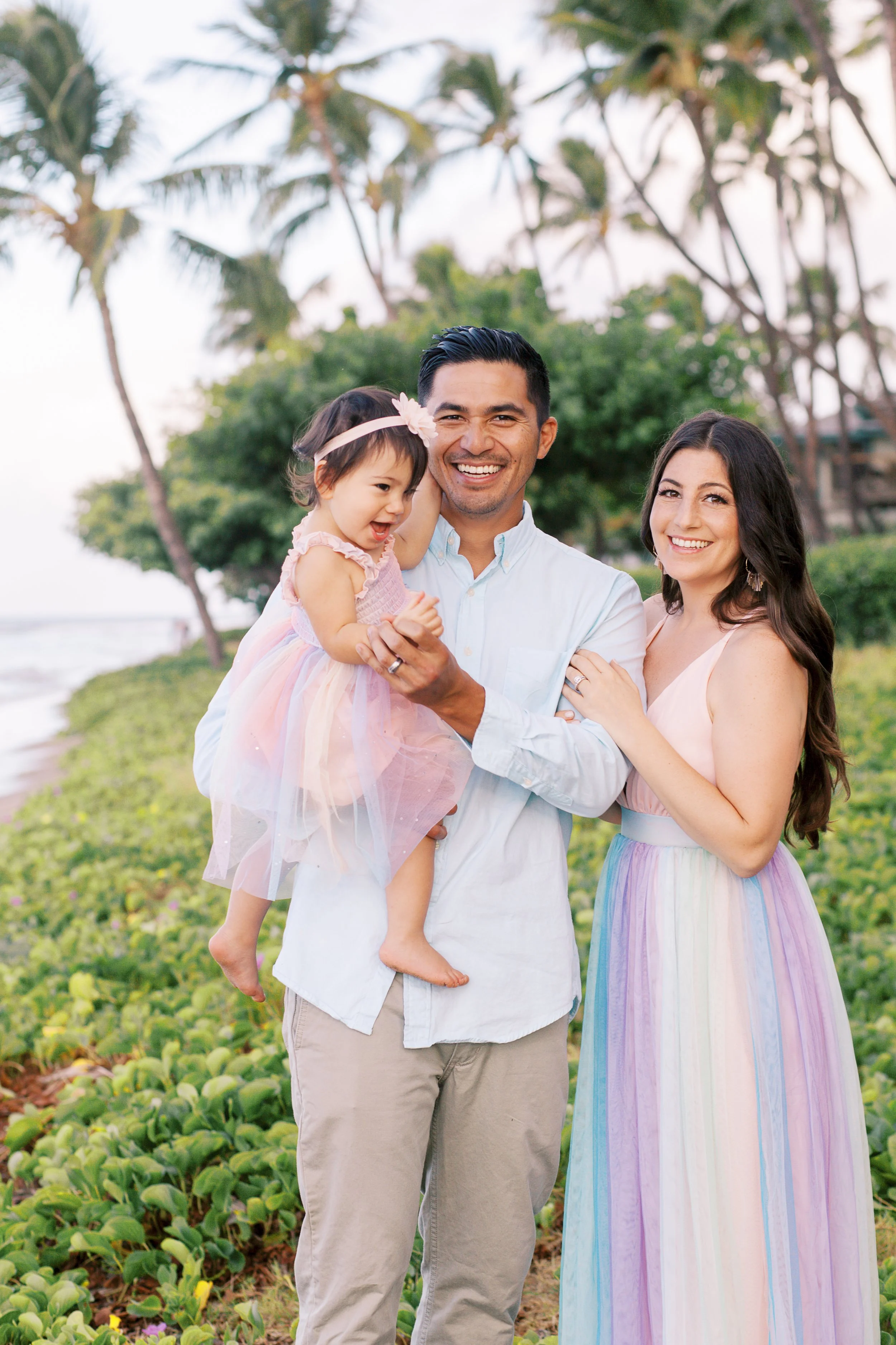A family of three laughing during a photoshoot in Lahaina Maui