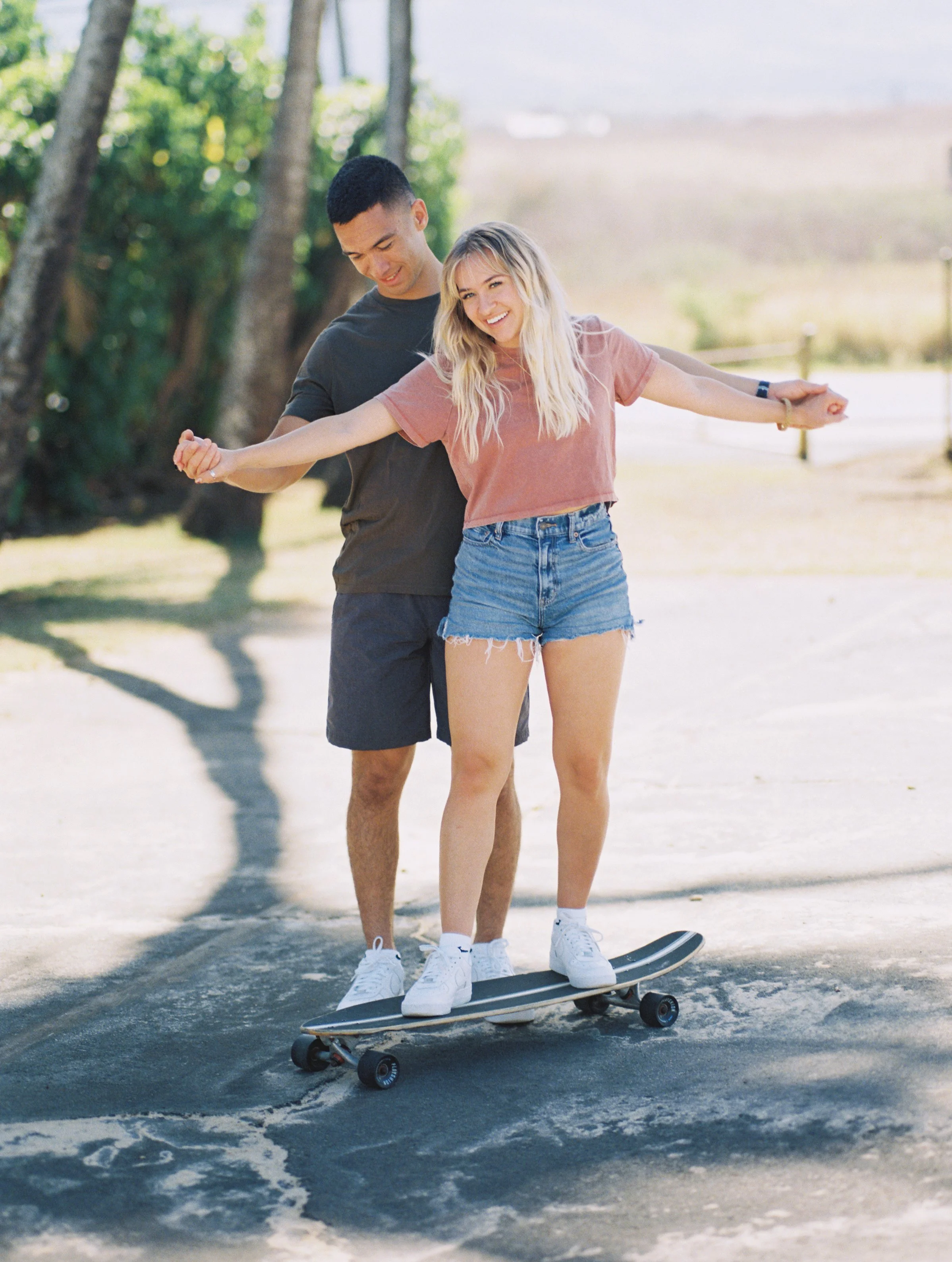 A couple skateboarding in Paia captured on film photography on the island of Maui.