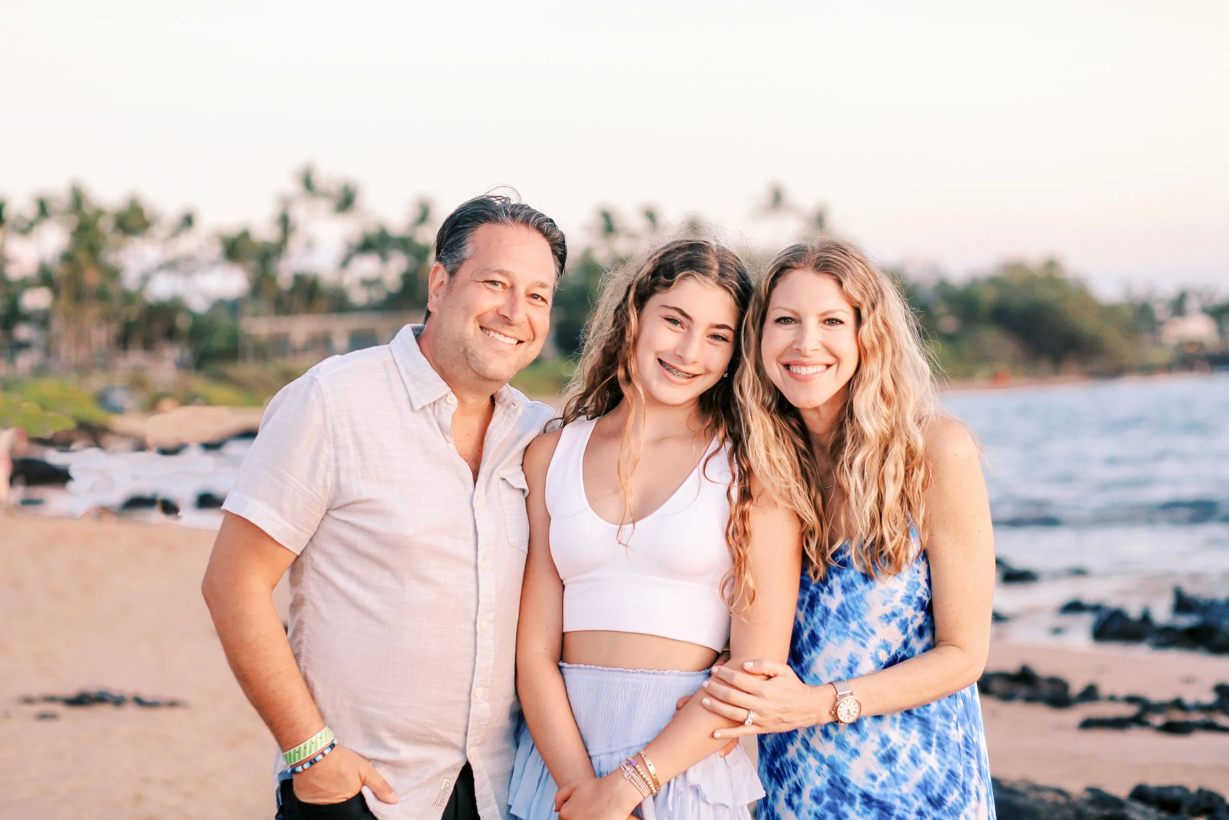 Family photographed at sunset on Maui beach during relaxed family photography session