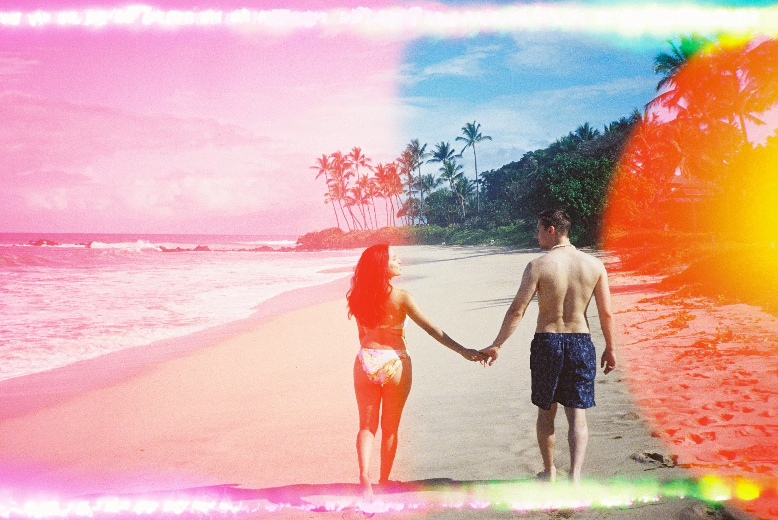 A couple running on a beach in Wailea Maui captured on rainbow 35mm film.