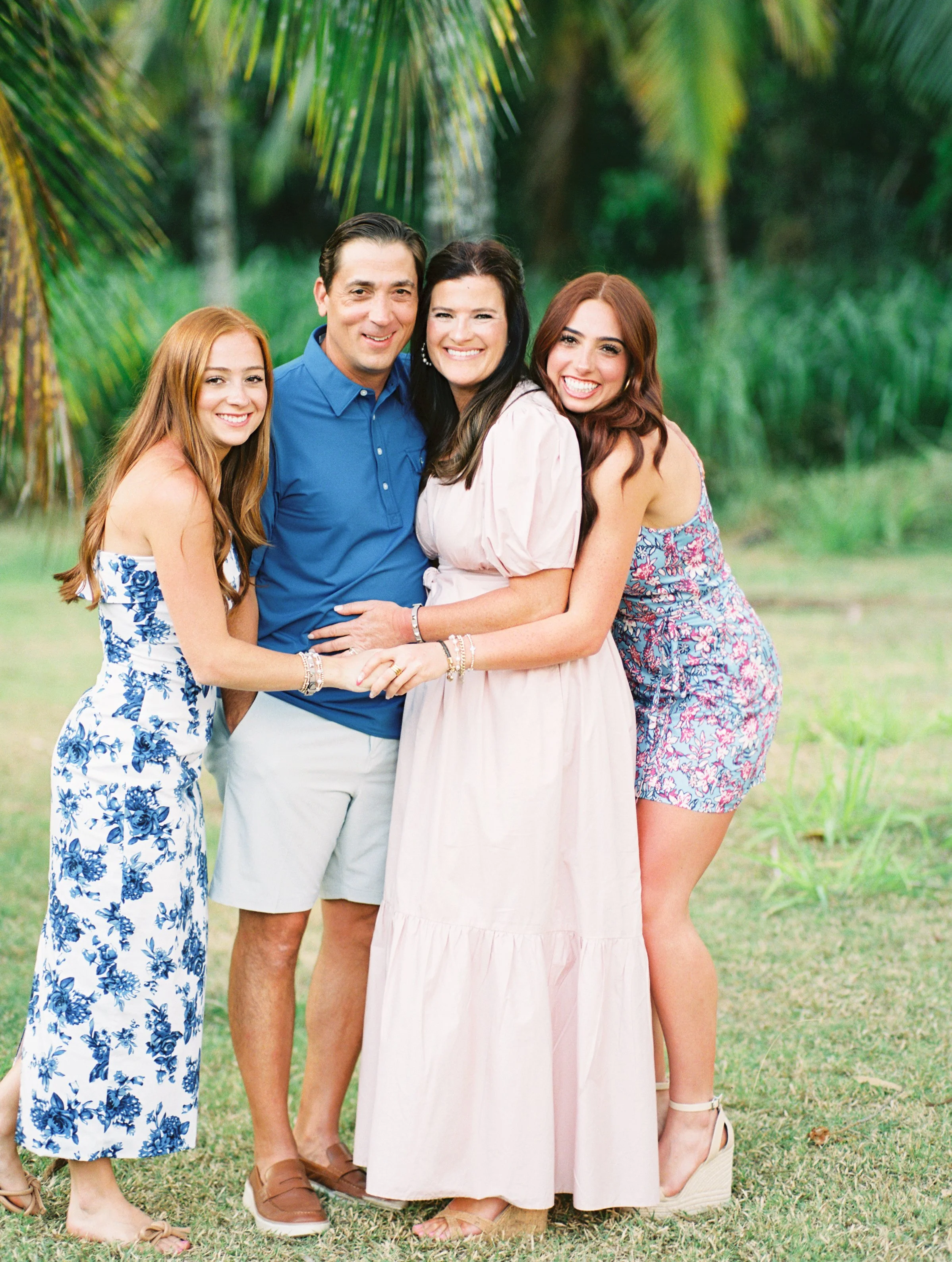 Maui family photographed on film during a photoshoot in Hawaii under palm trees in Kapalua.