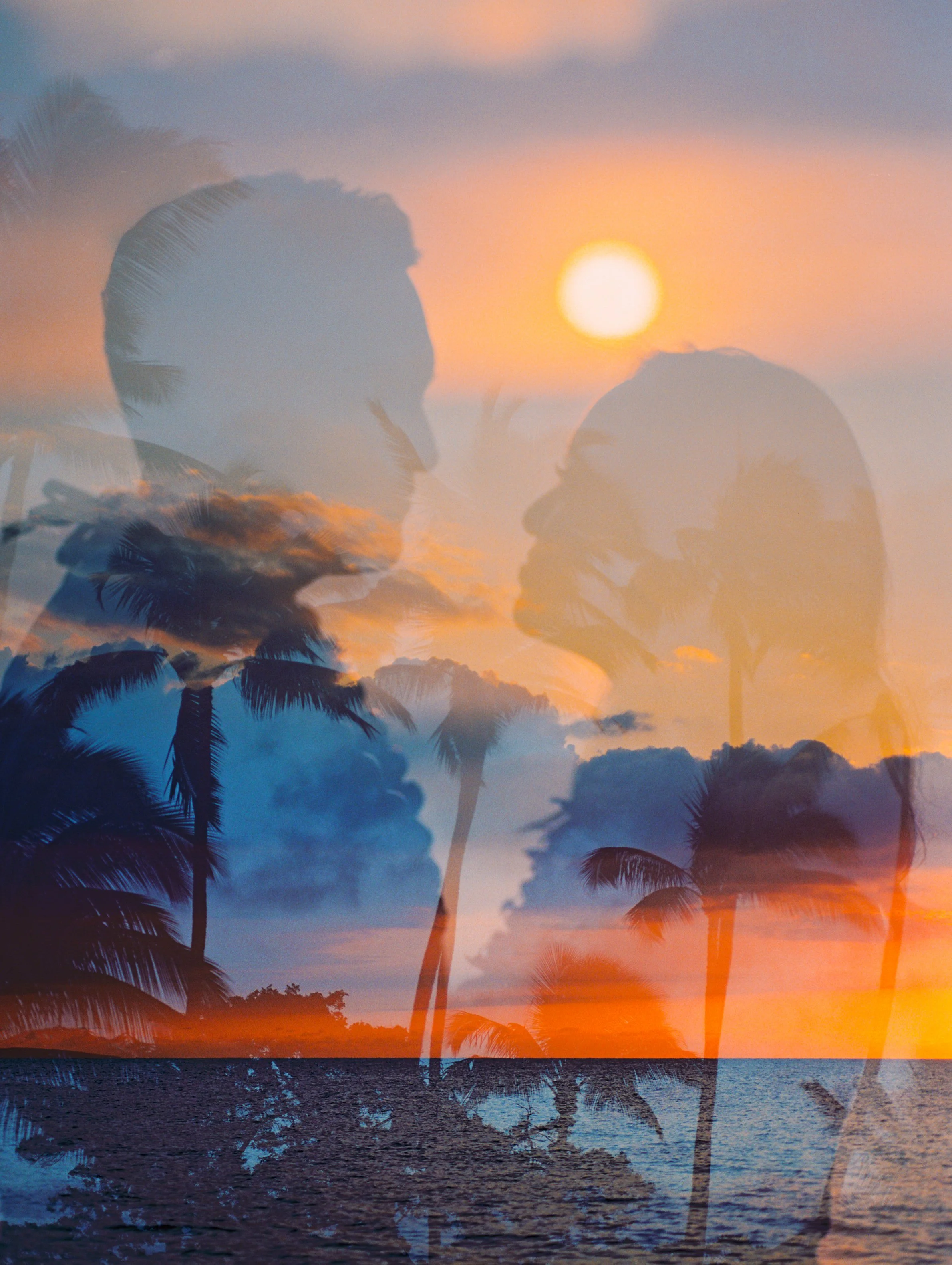 A double exposure of a couple with palm trees and the sunset in Maui Hawaii captured on a Contax 645.
