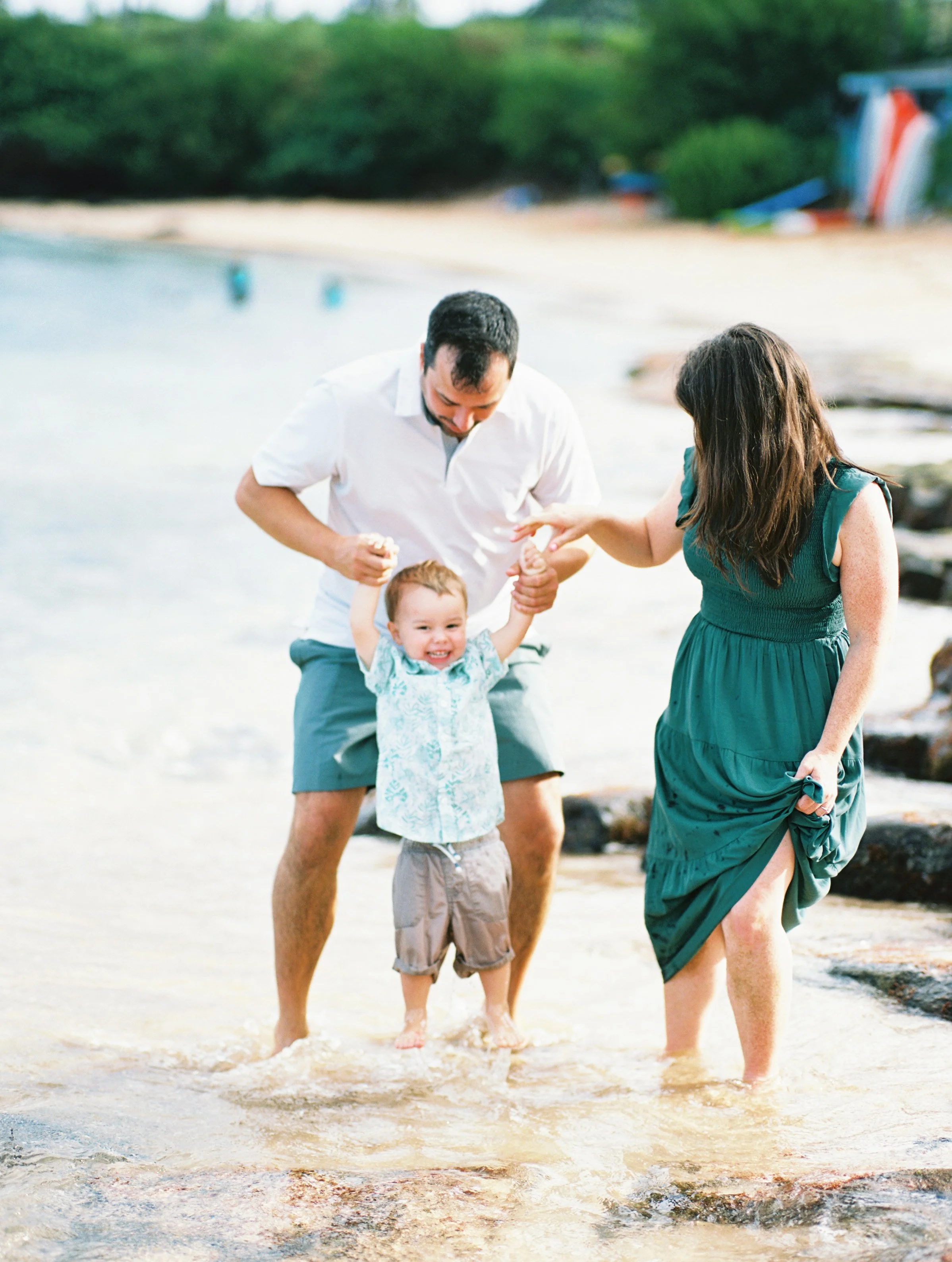 Family playing together in the water photographed on film at Kapalua Bay.