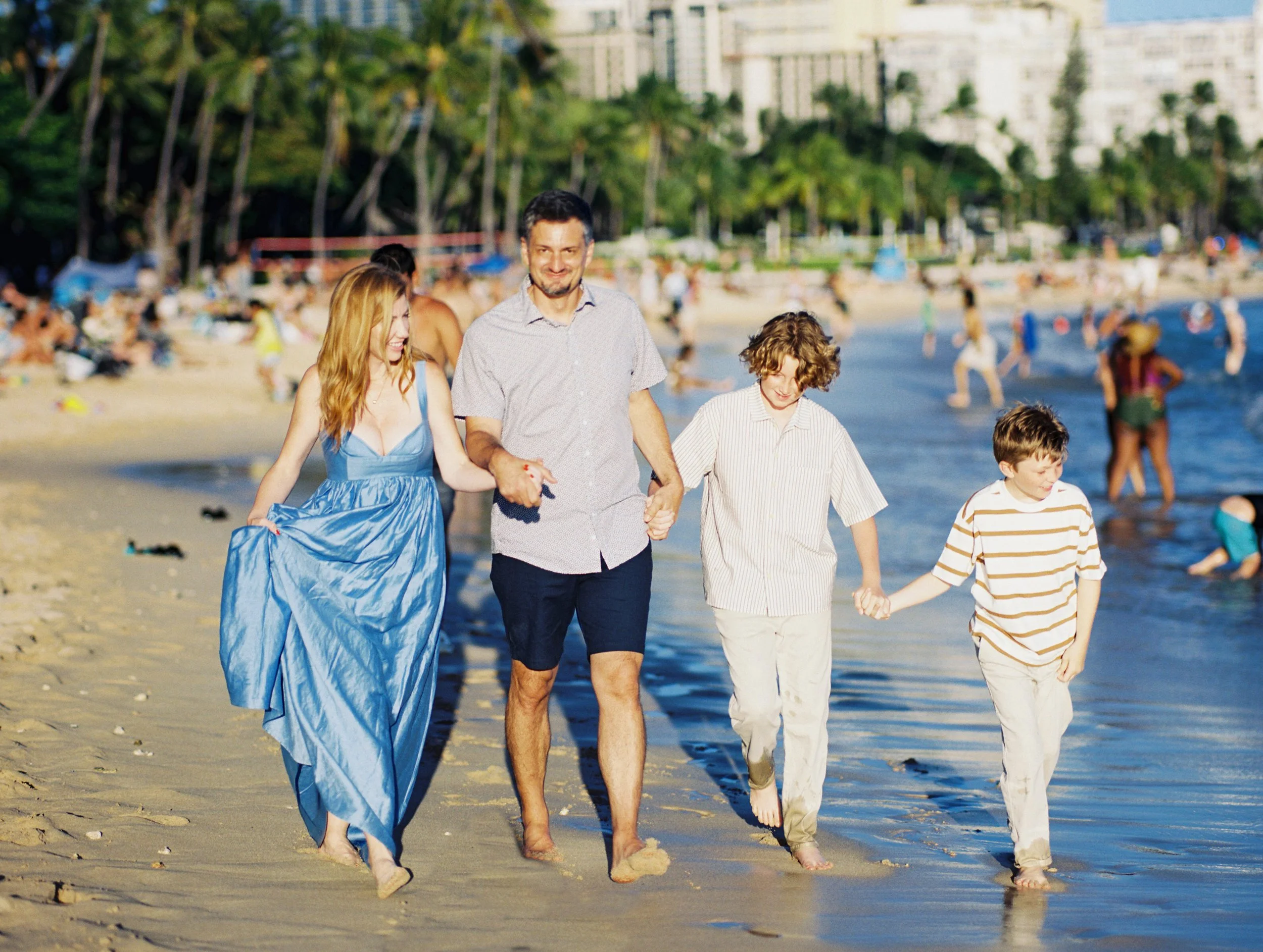 O'ahu family film photographer capturing photos on Waikiki at sunset