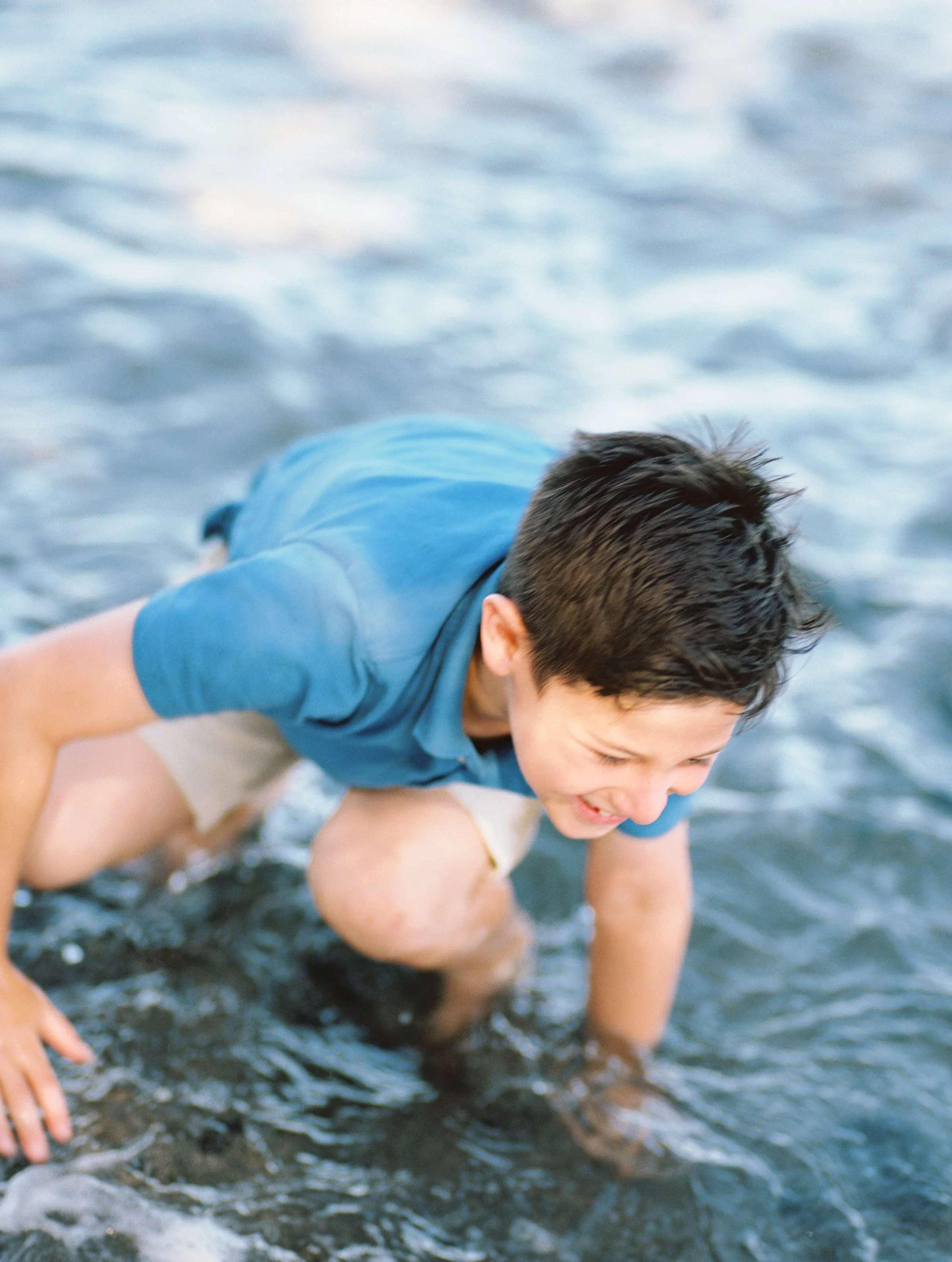 A boy splashing in the water in Maui Hawaii captured on film.