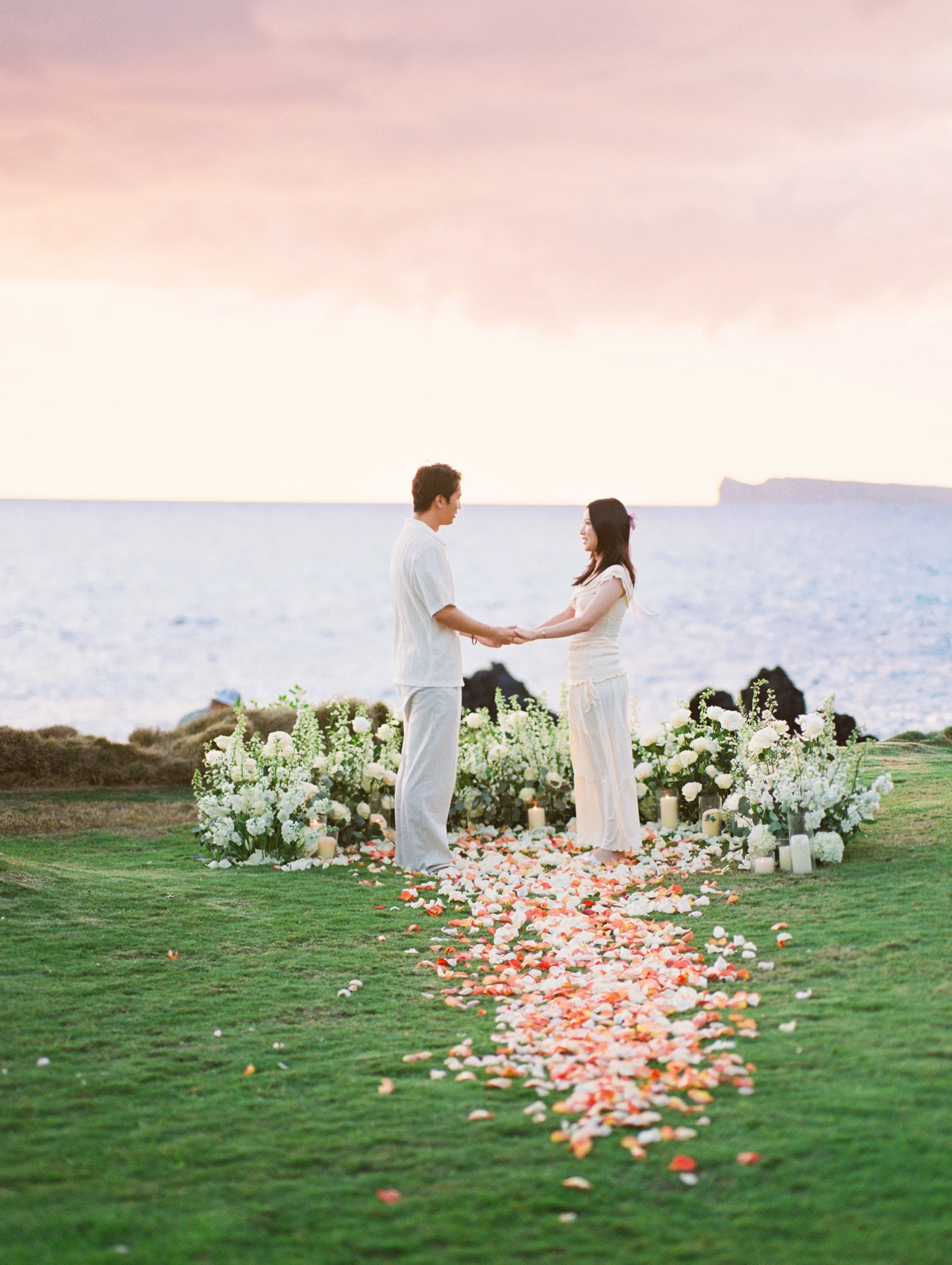 A private proposal during sunset at White Orchid Beach House located on Maui.