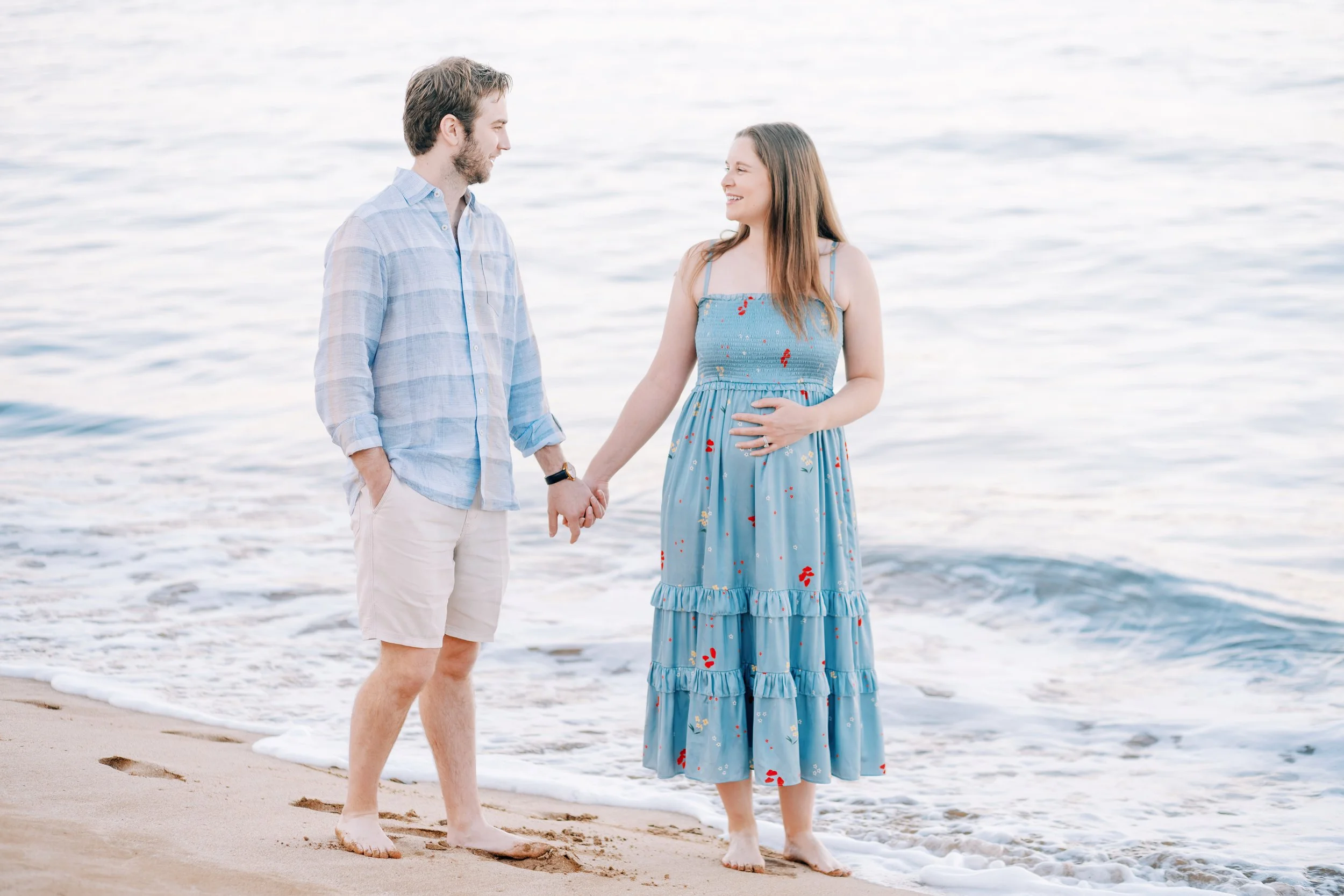 maui baby moon couple holding hands on the beach