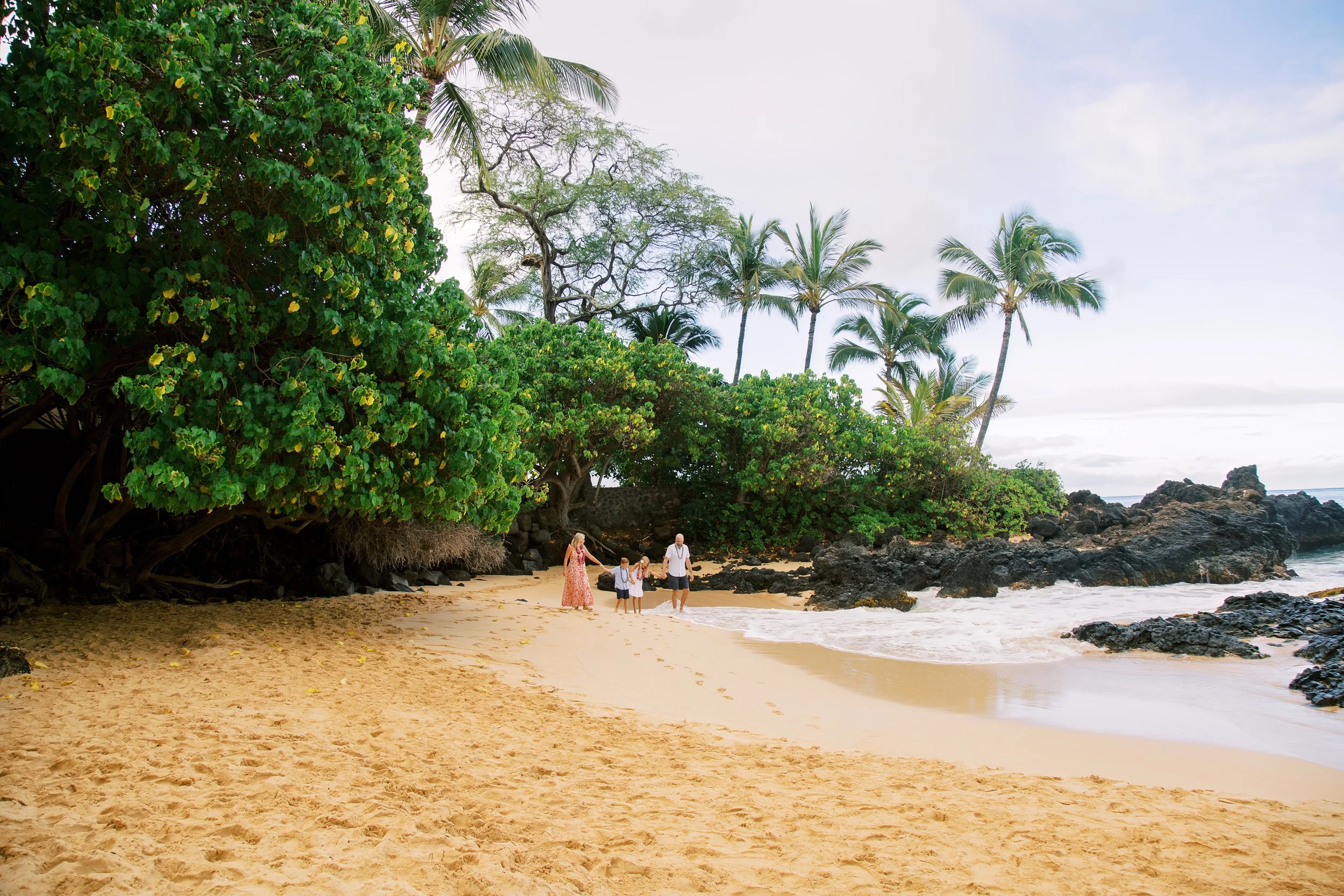 Family walking together at Makena Cove during sunrise in Maui