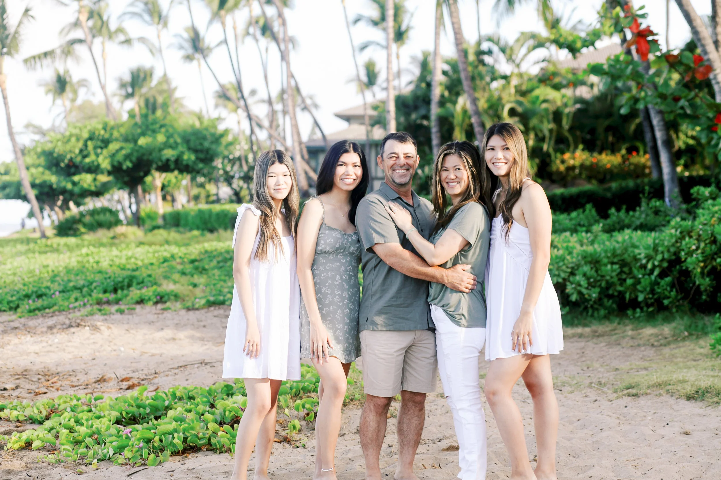 A family standing together on a beach in Lahaina Maui near Kaanapali for family photos.