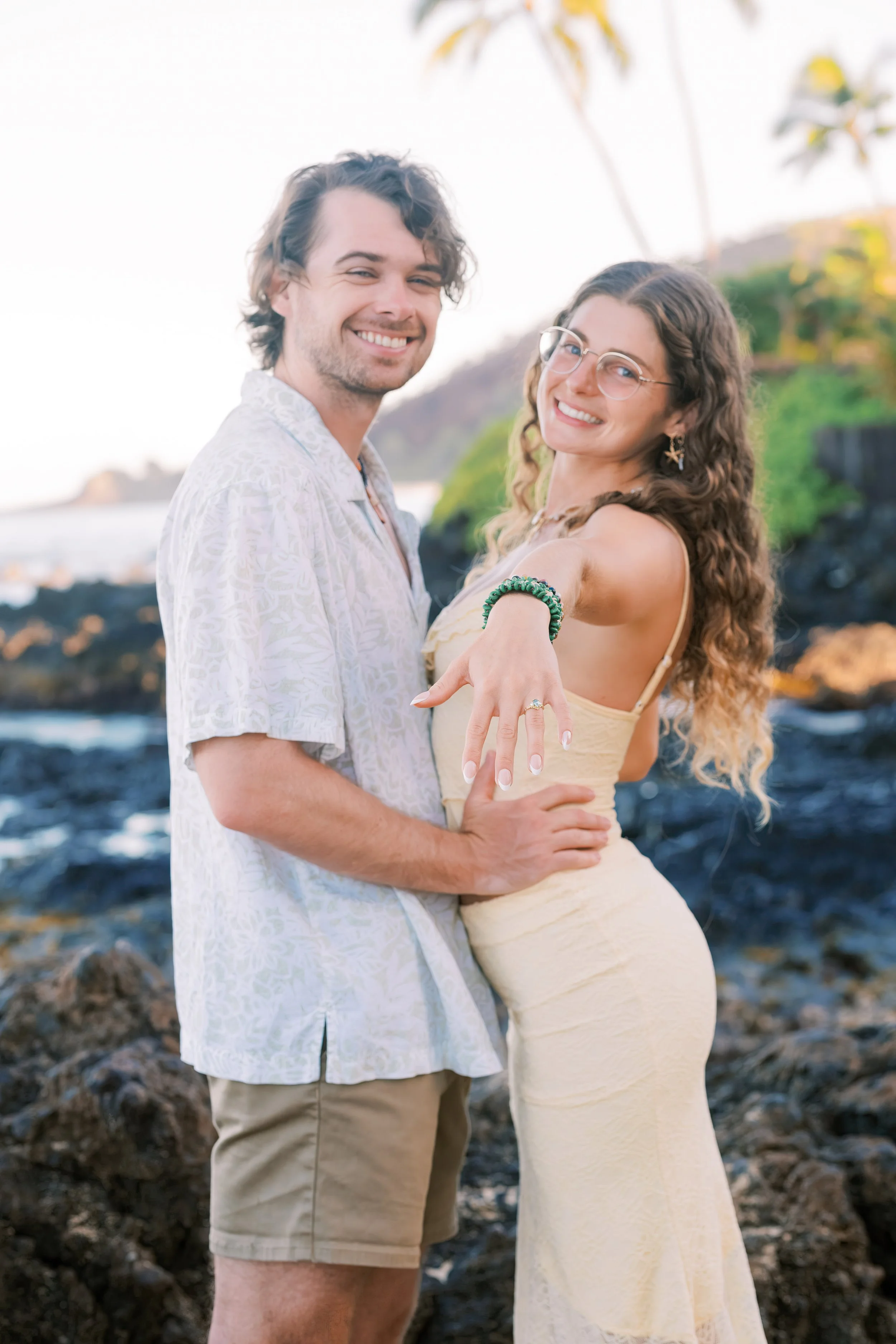 A newly engaged couple during sunrise at Makena Cove in Maui.