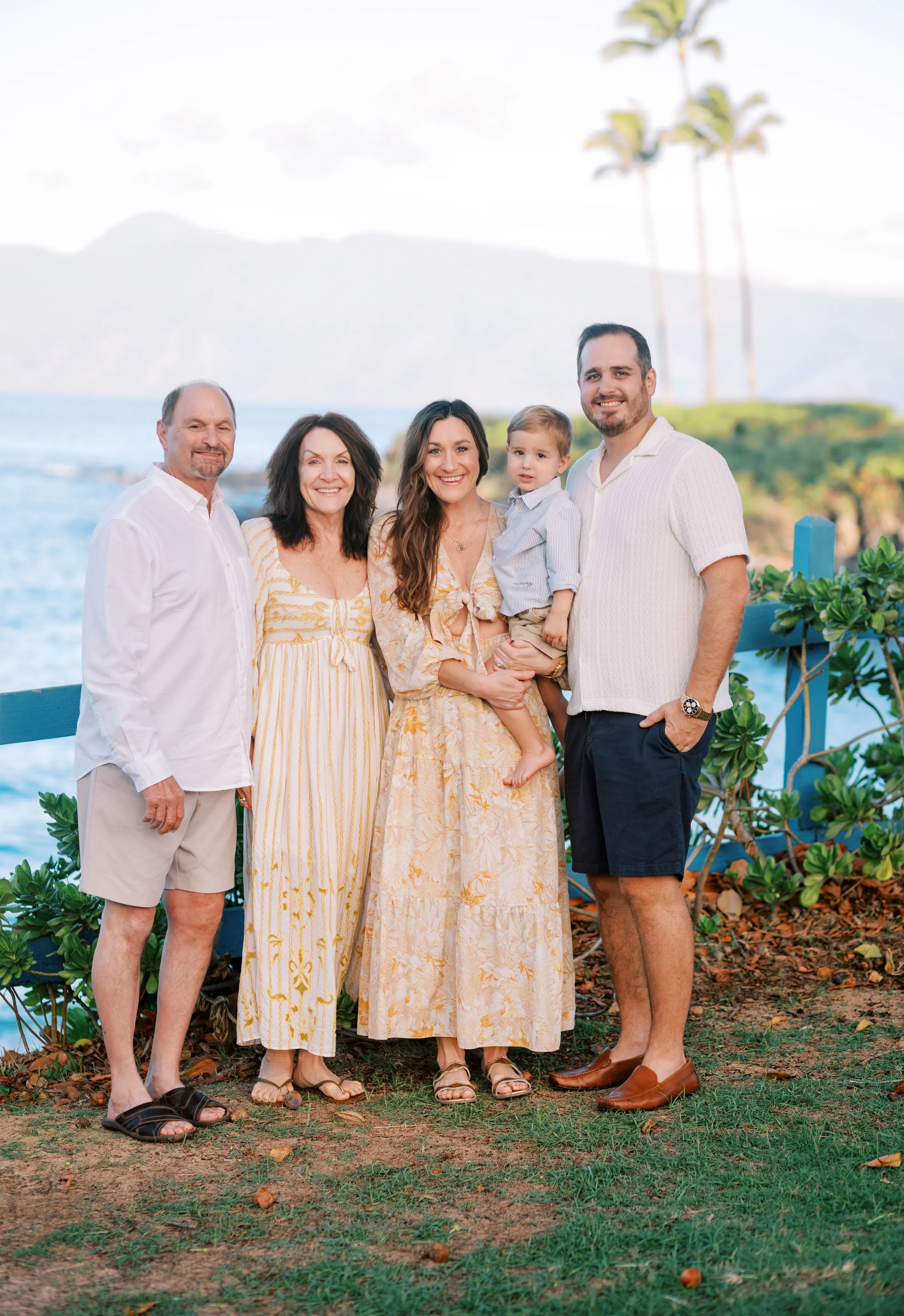 A family smiling for a morning photoshoot at Kapalua Bay.