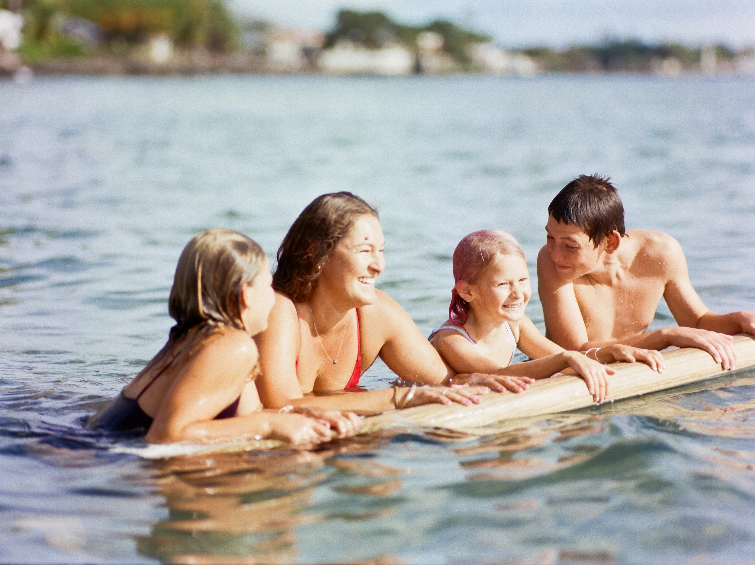 Children playing in the ocean during a Maui film session.