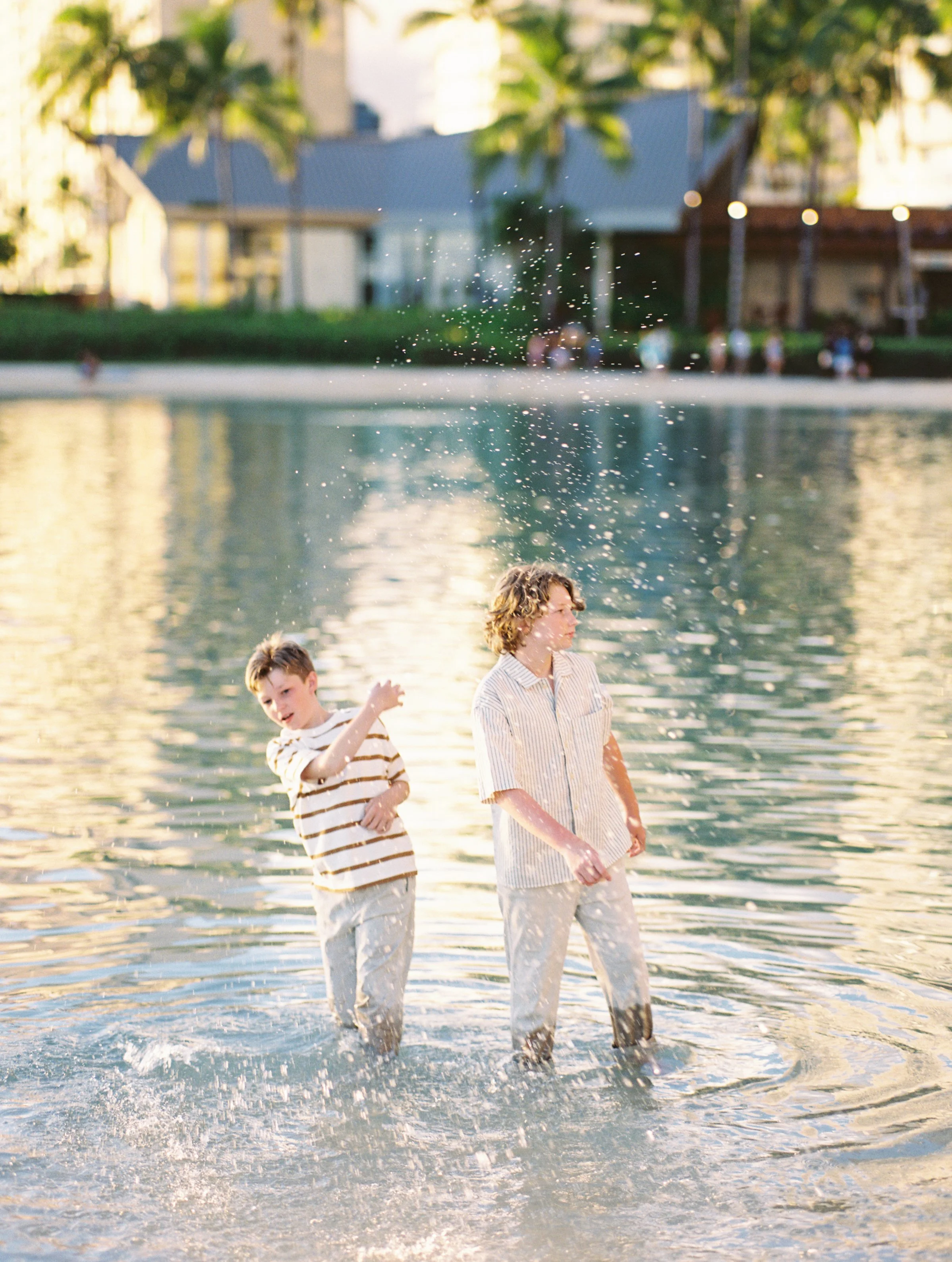 Family portraits in the water captured on film during sunset.