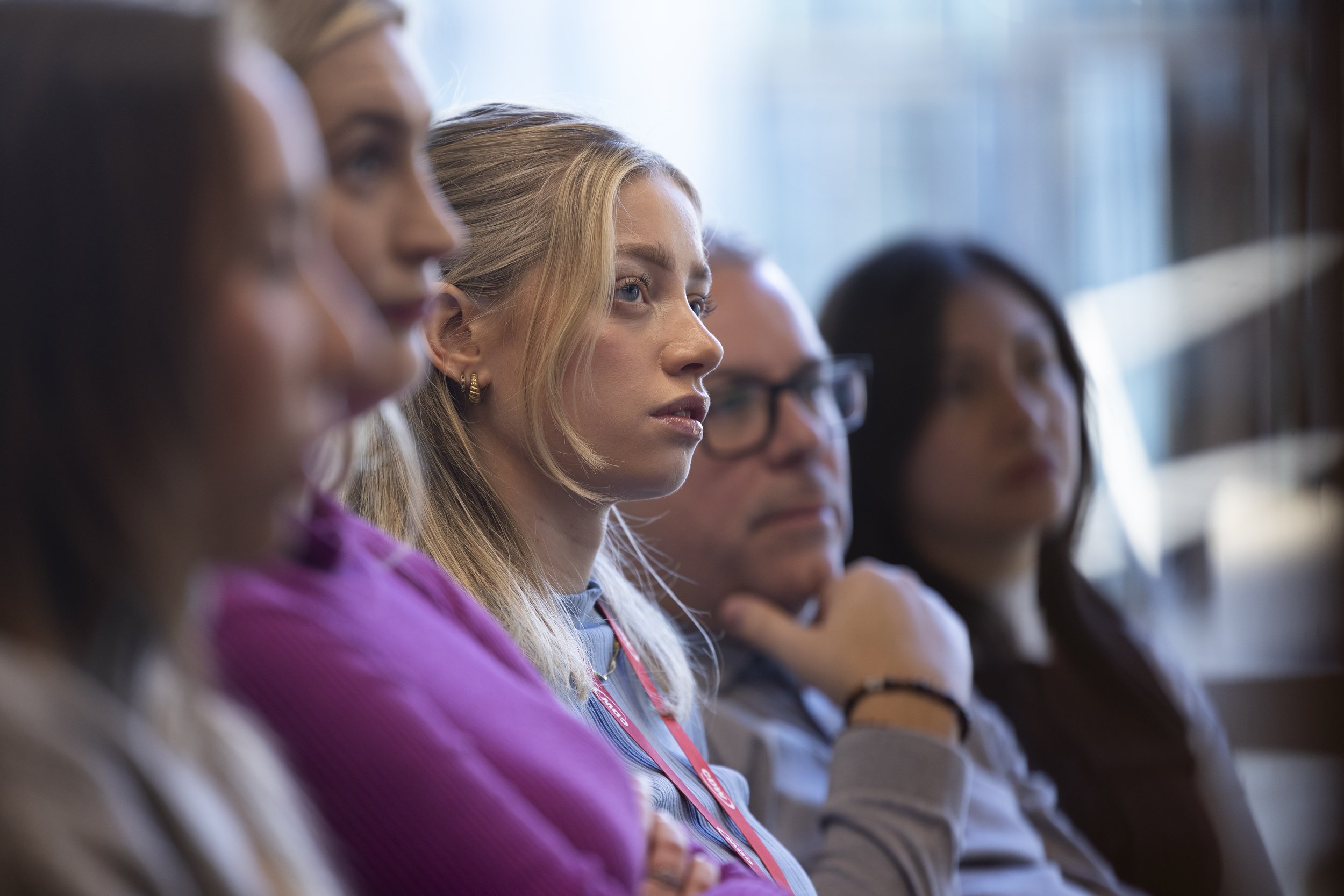 Conference photography Manchester of woman attendee focused during CDW corporate event