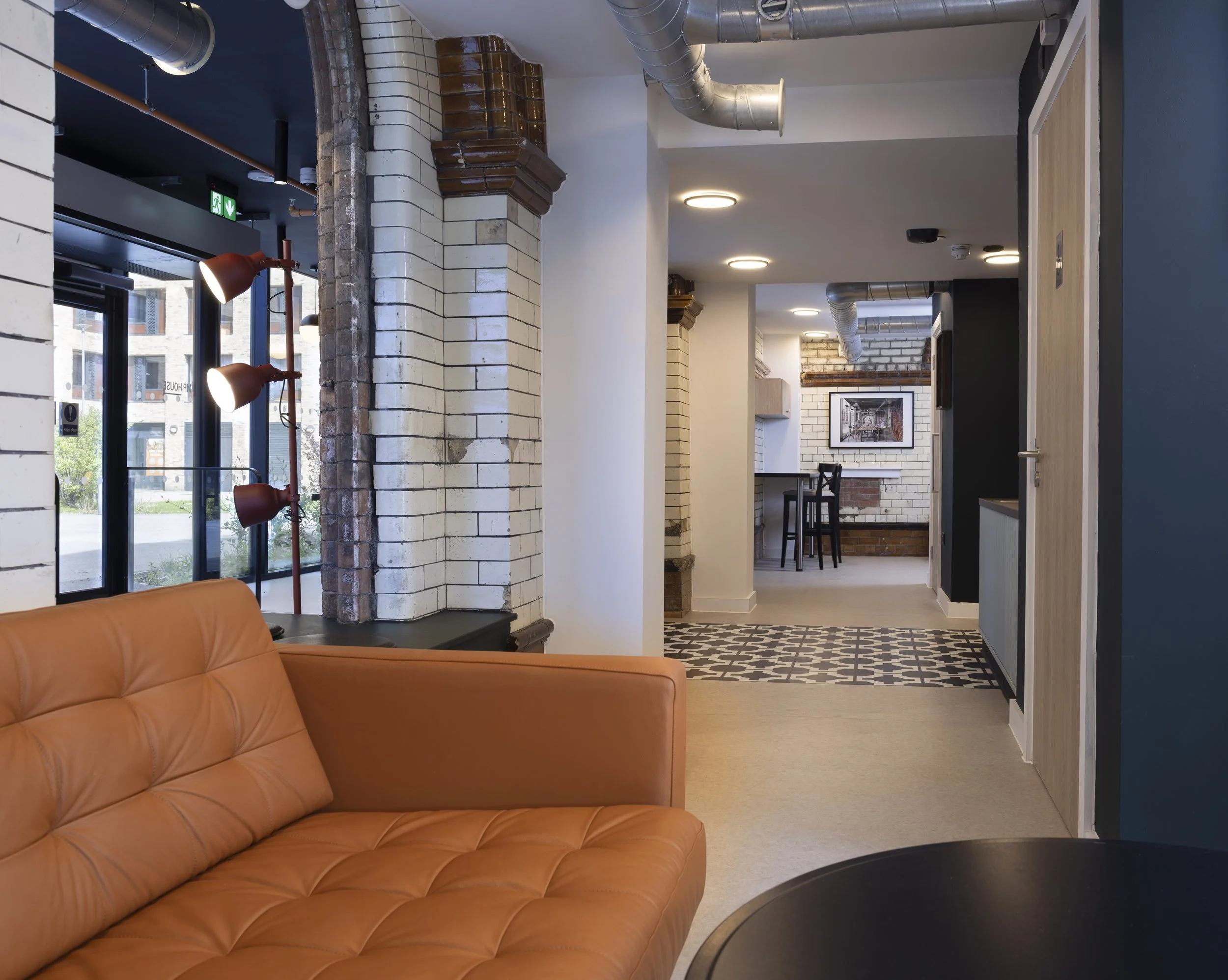 View looking down corridor from kitchen area inside The Pump House by Just H Architects showing interior circulation space