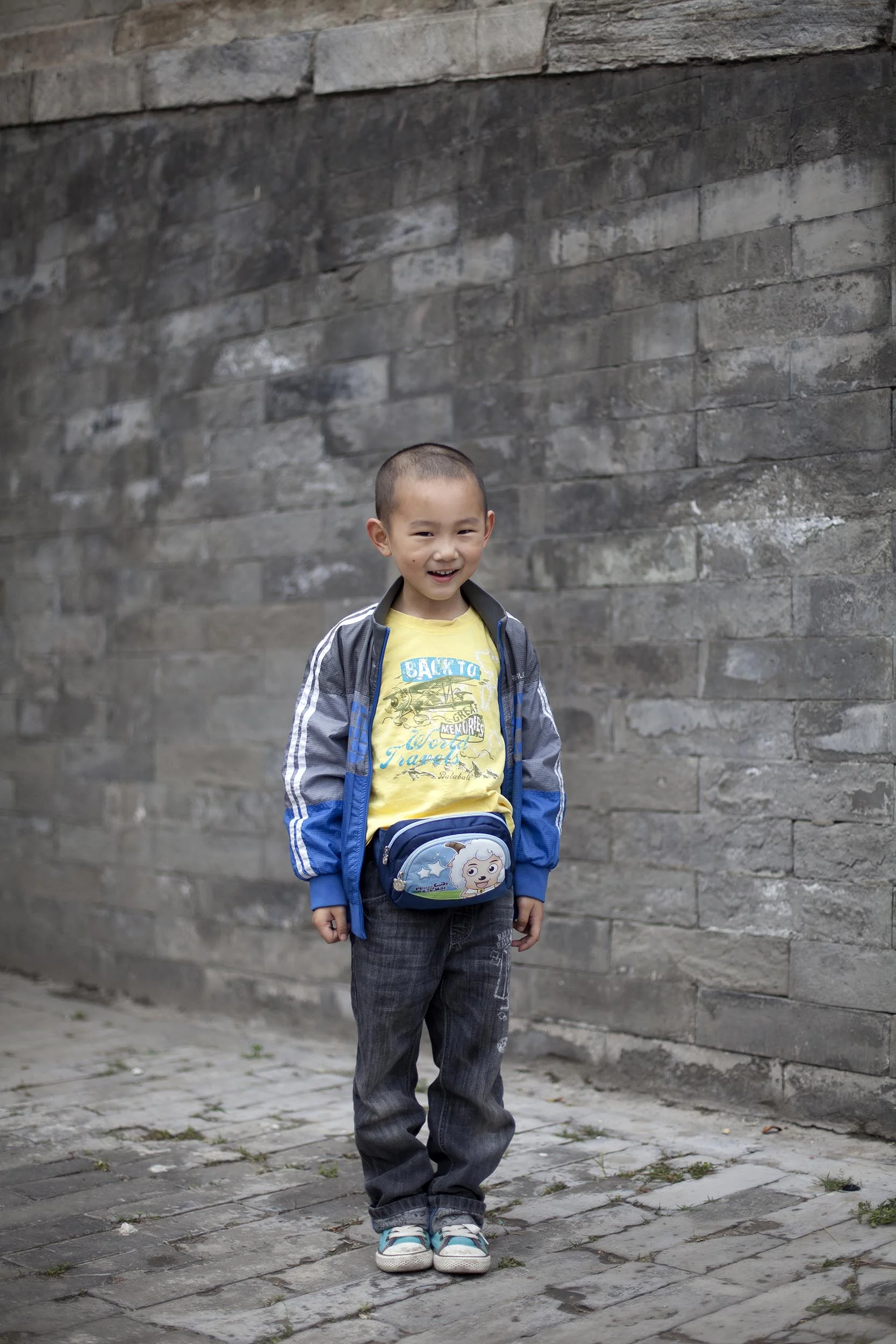 A portrait photograph of a young boy in the Forbidden City, Beijing , China Documentary photography part of a personal project