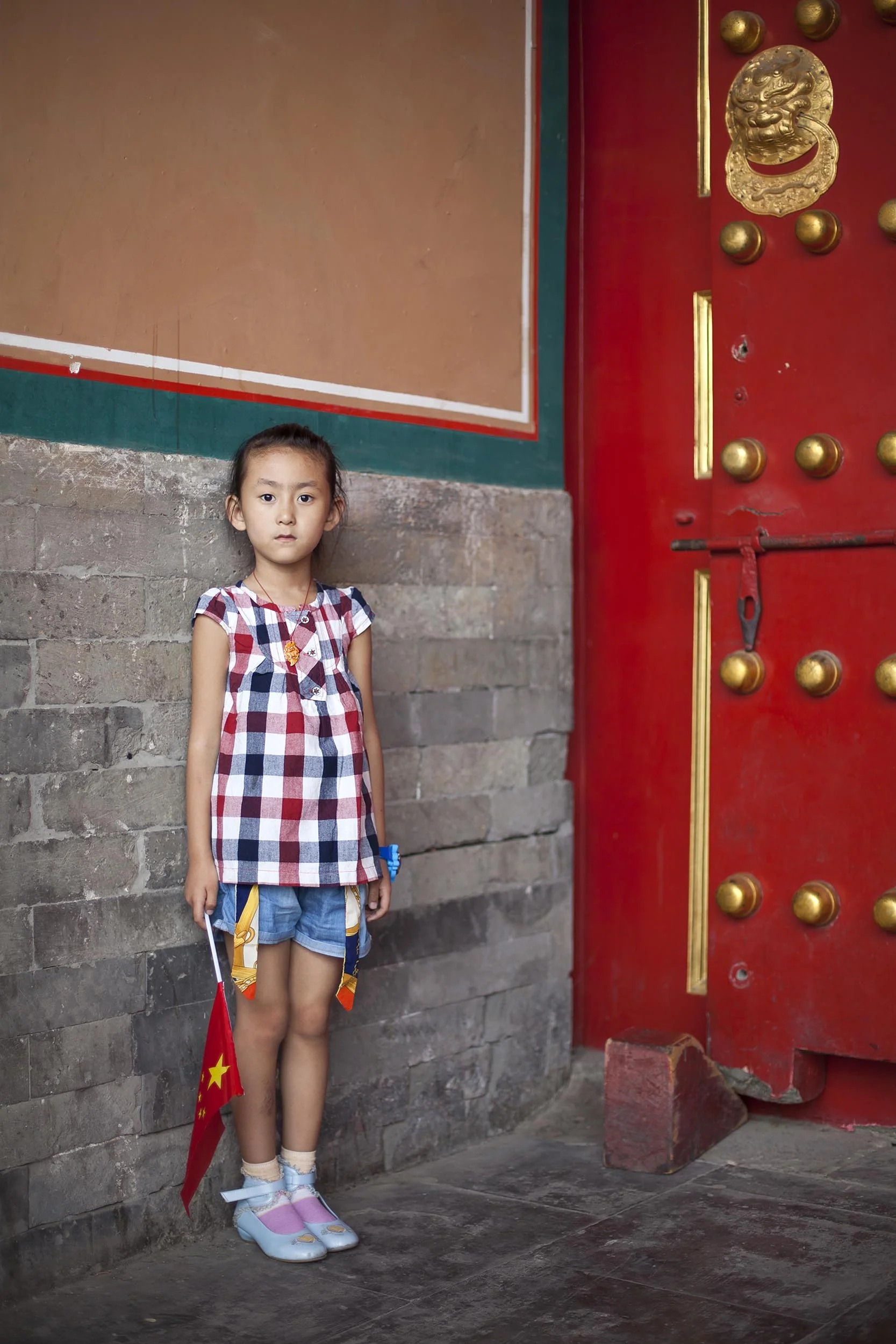 A portrait photograph of a young girl in the Forbidden City, Beijing , China Documentary photography part of a personal project