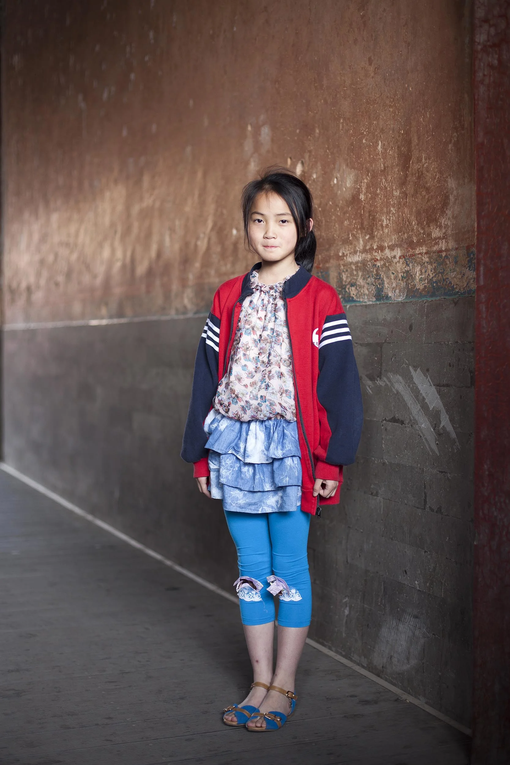 A portrait photograph of a young girl in the Forbidden City, Beijing , China Documentary photography part of a personal project