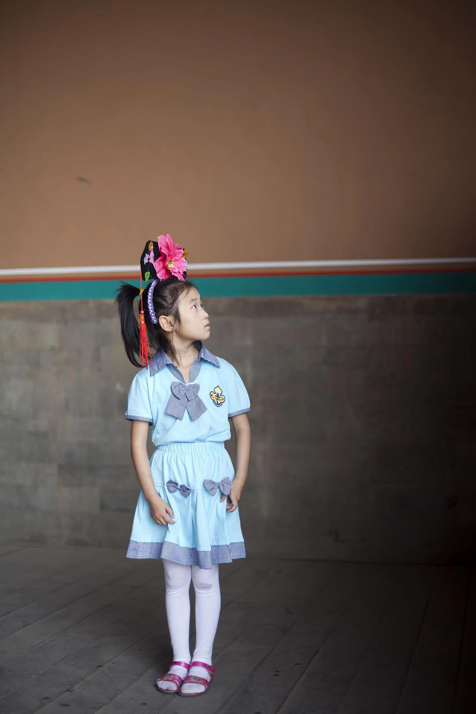 A portrait photograph of a young girl in the Forbidden City, Beijing , China Documentary photography part of a personal project