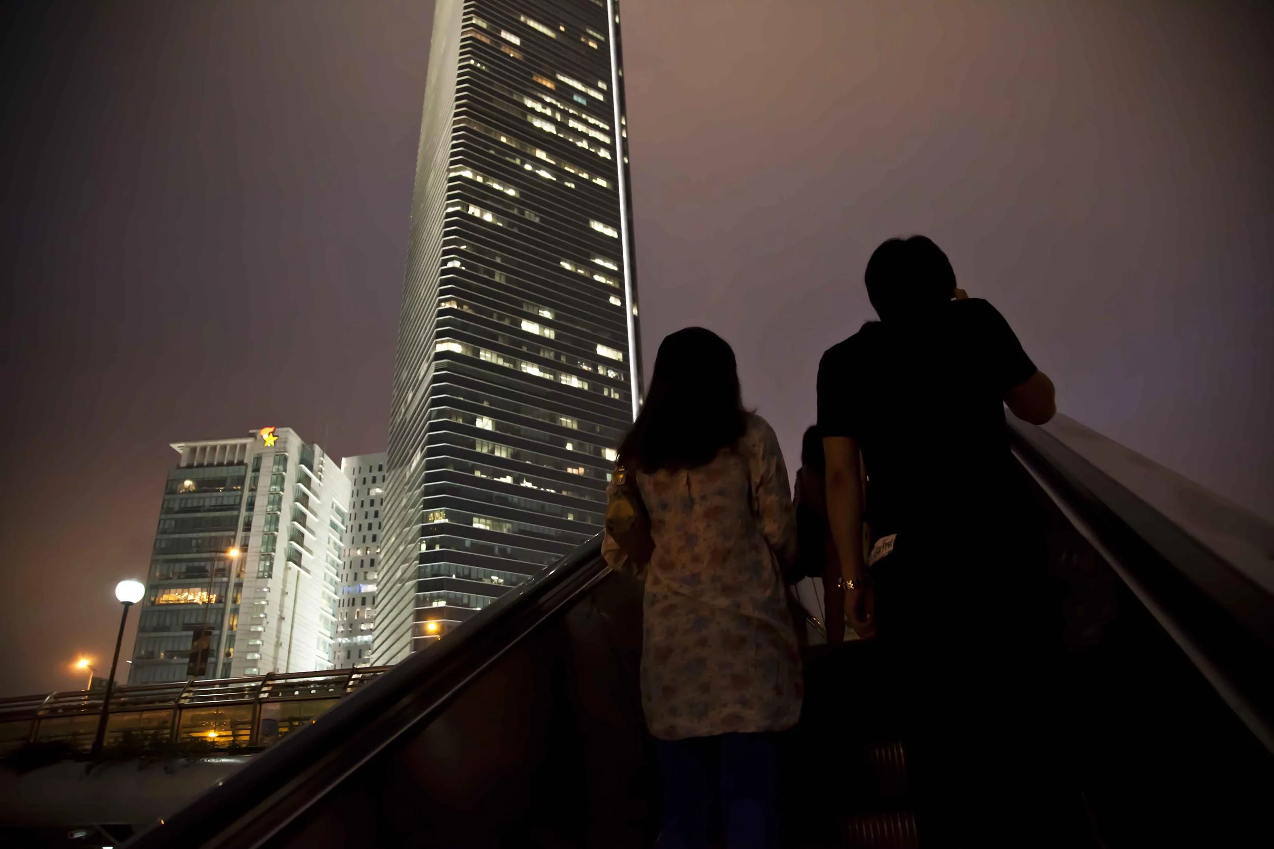 A photograph of people on an escalator at night Shanghai, China Photography for personal project