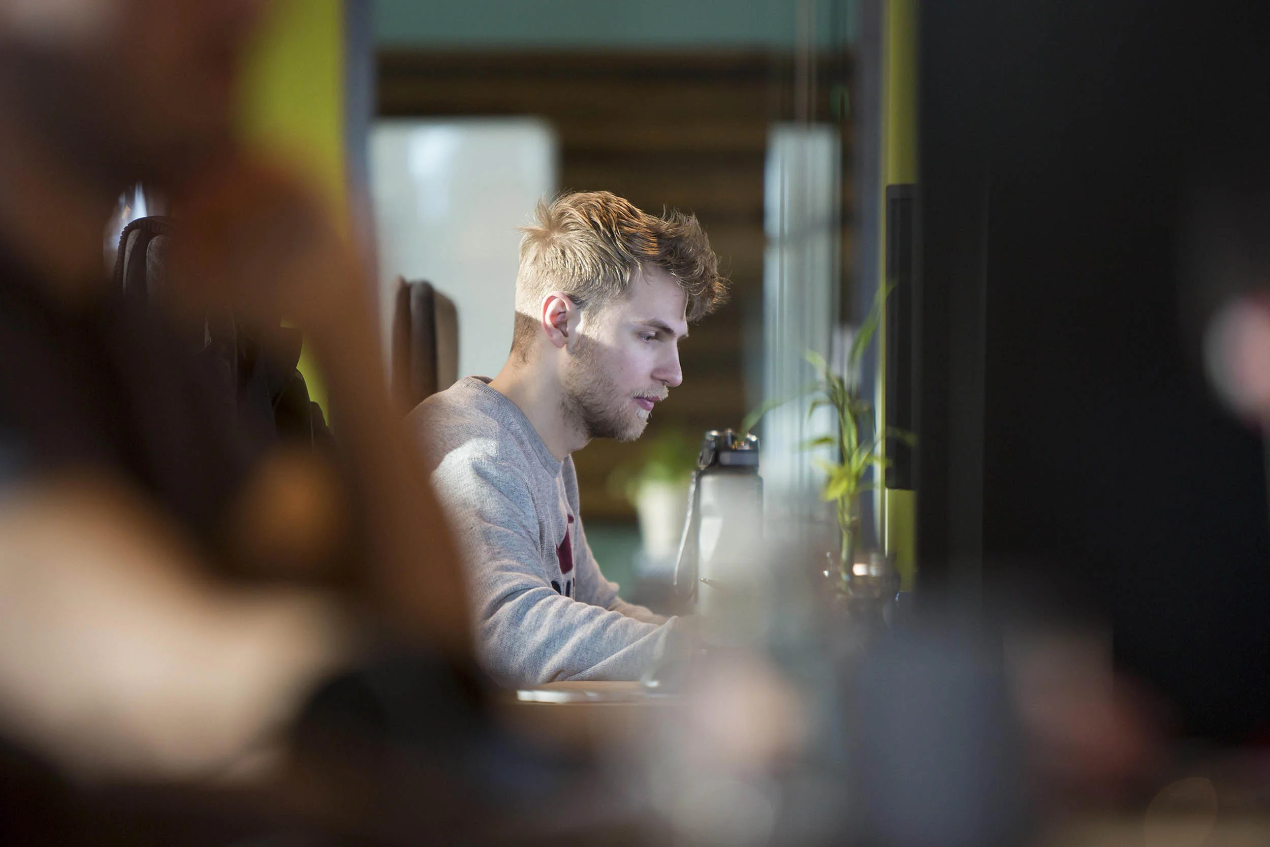  Portrait photograph of a staff member at Cubic Motion, Manchester working on computer game animation 