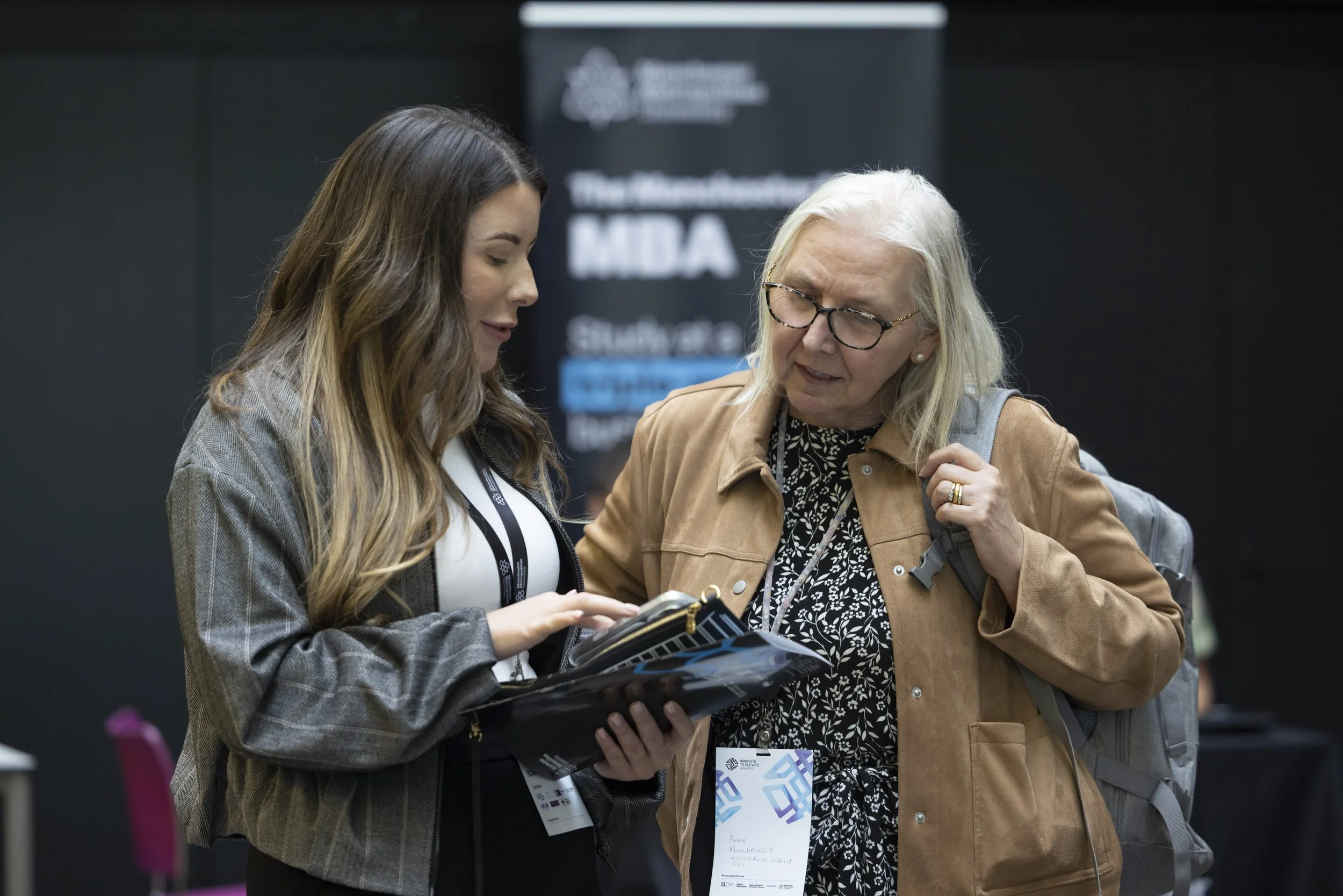 Two women discuss the programme at a conference in Manchester